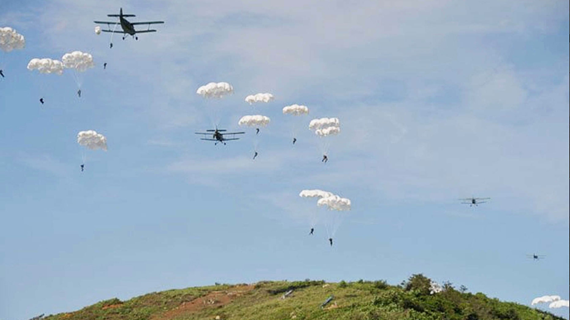 North Korea paratroopers jump out of two Antonov An-2 transport aircrafts.