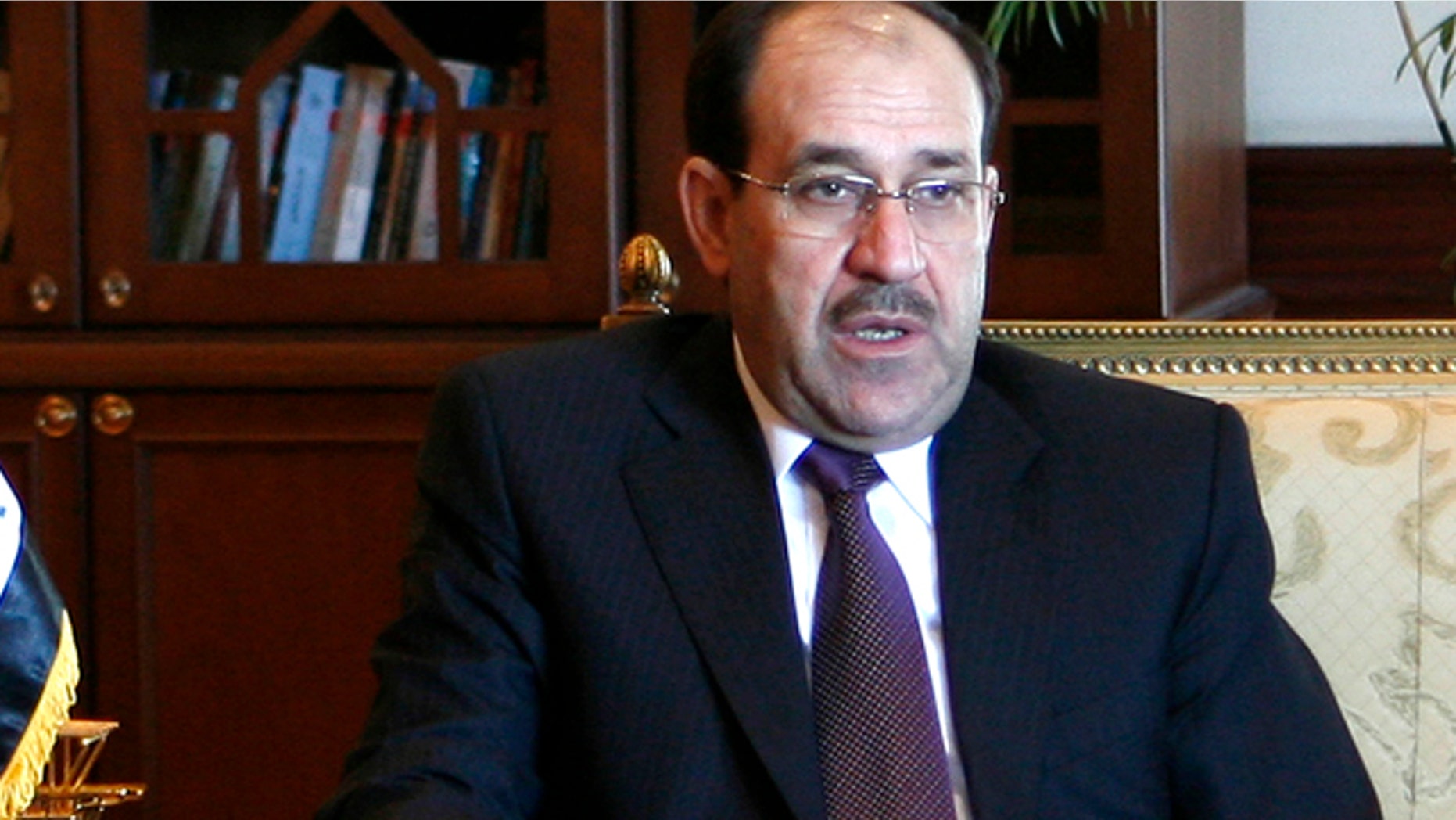 FILE 2009: Iraq's Prime Minister Nouri Maliki gestures during talks with his Egyptian counterpart Ahmed Nazif in Cairo.
