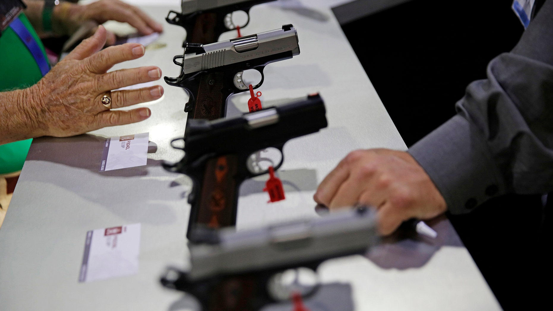 Guns sit on display at the NRA annual convention where President Donald Trump is scheduled to speak later in the day in Atlanta, Friday, April 28, 2017. (AP Photo/David Goldman)
