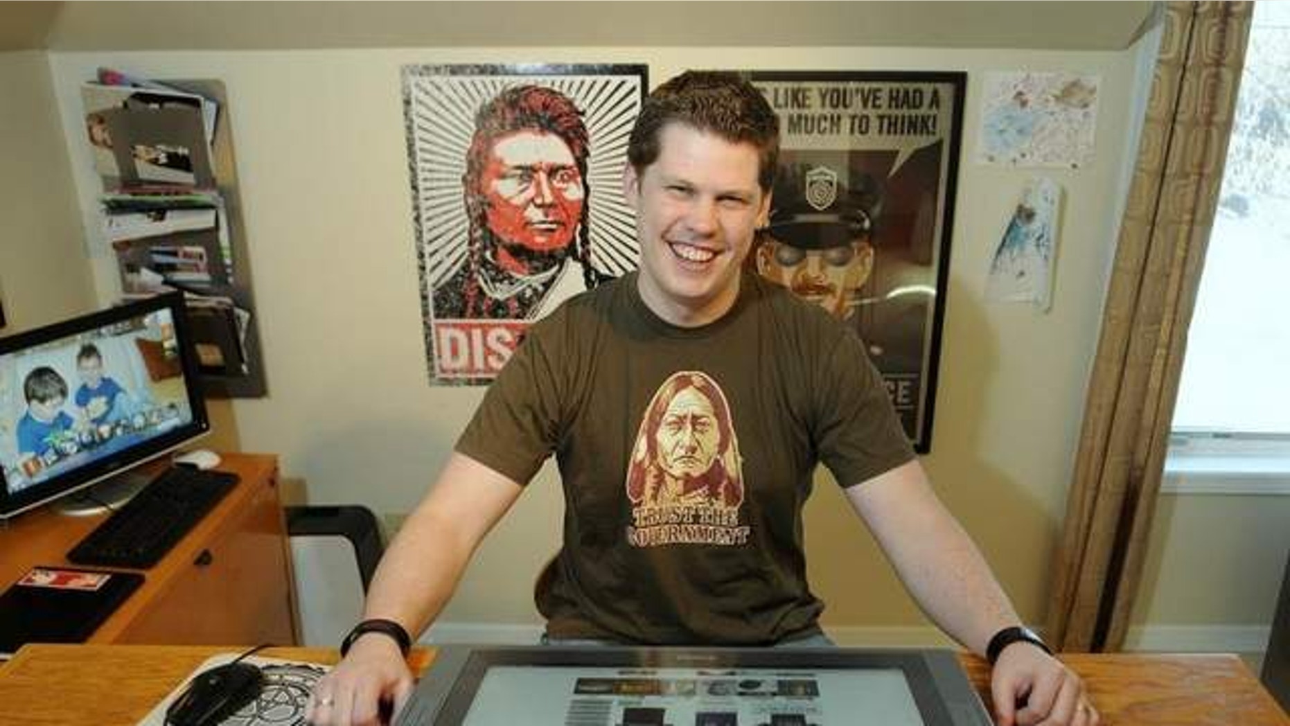 FILE: Nov. 29, 2011: Dan McCall is photogrpahed in his home in Sauk Rapids, Minn. Federal authorities have dropped an attempt to stop a Minnesota man from marketing merchandise poking fun at the National Security Agency for its surveillance of citizens.