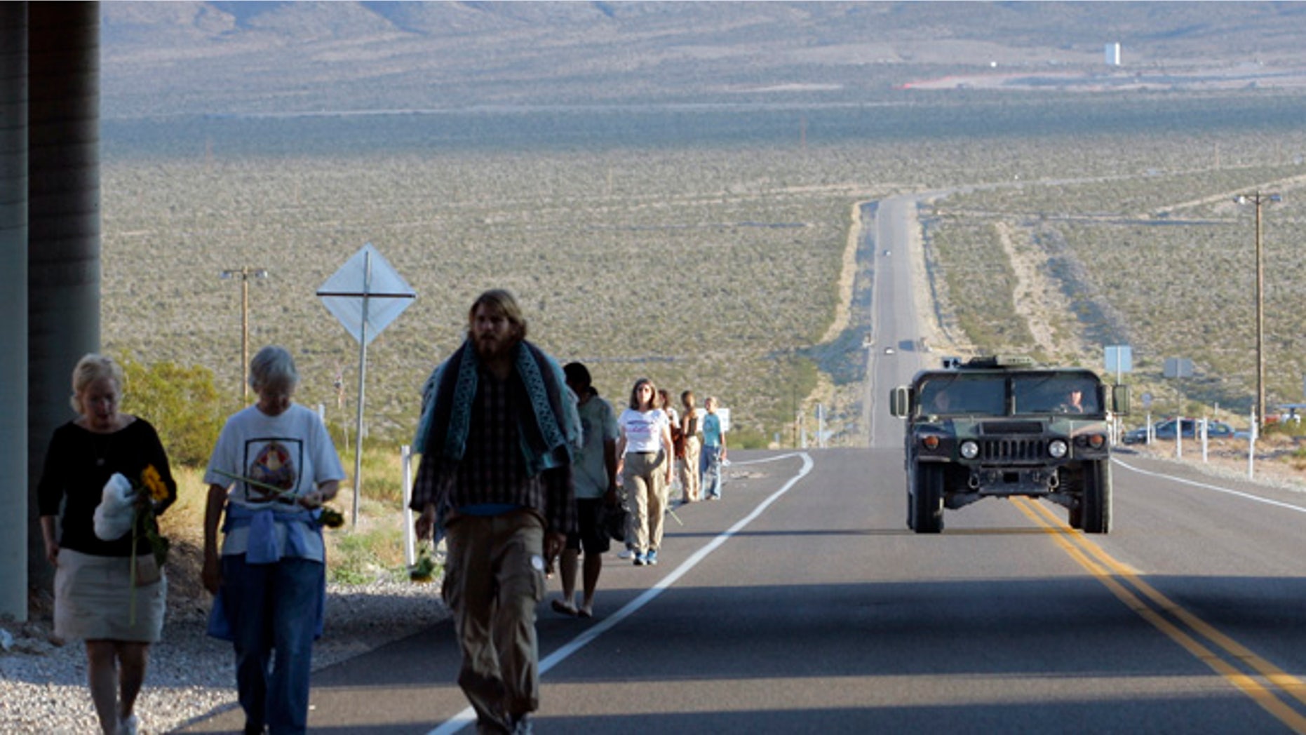 A U.S. Air Force humvee is driven past as anti-nuclear activists walk after a sunrise ceremony just outside the Nevada test site near Mercury, Nevada, 60 miles north of Las Vegas.
