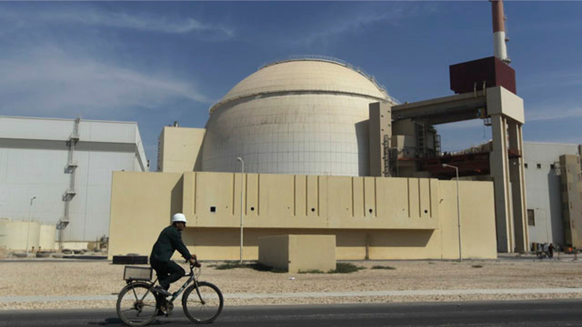 Oct. 26, 2010: A worker rides a bike in front of the reactor building of the Bushehr nuclear power plant, just outside the southern city of Bushehr, Iran.