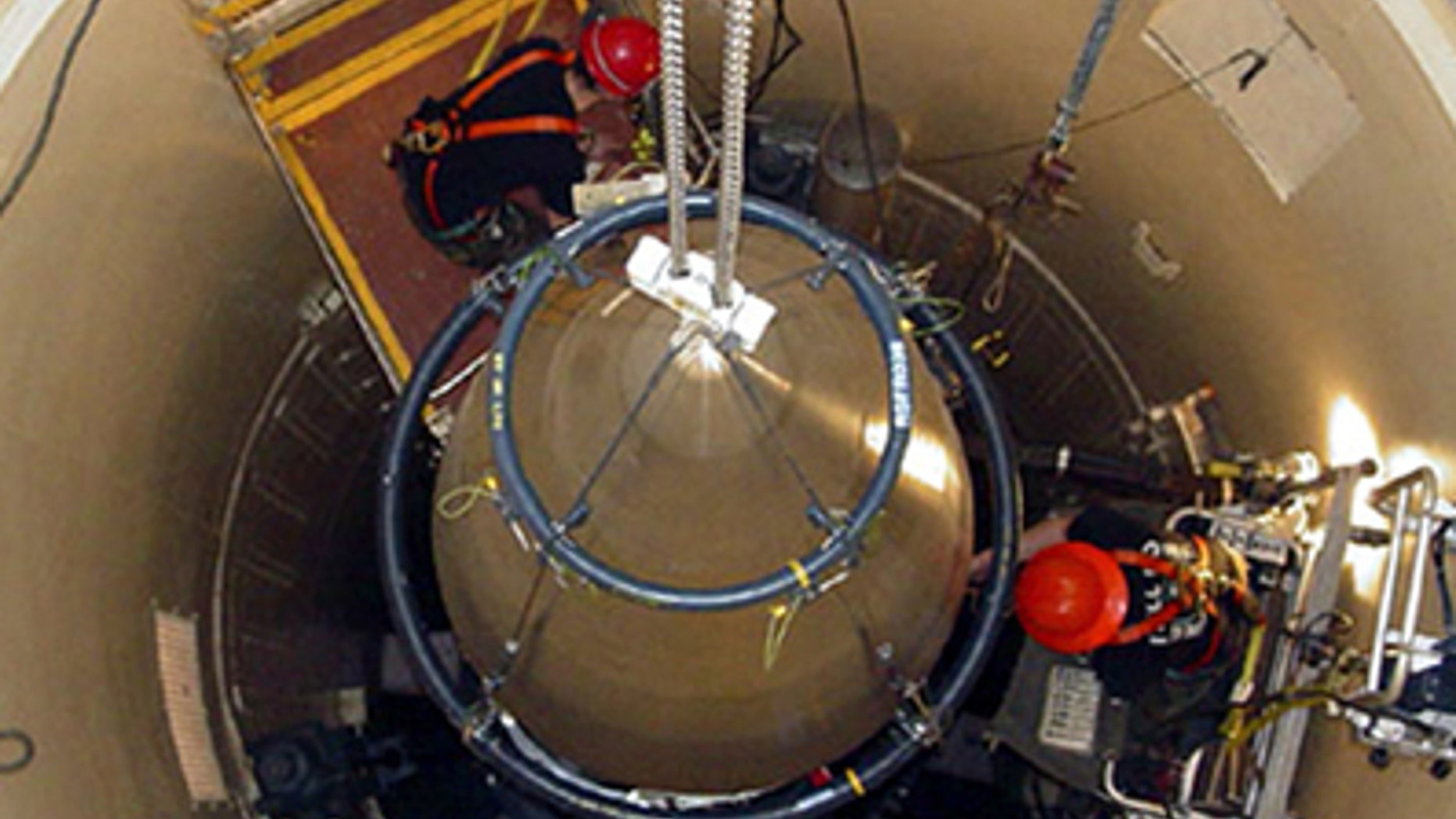 A Malmstrom Air Force Base missile maintenance team removes the upper section of an ICBM at a Montana missile site.