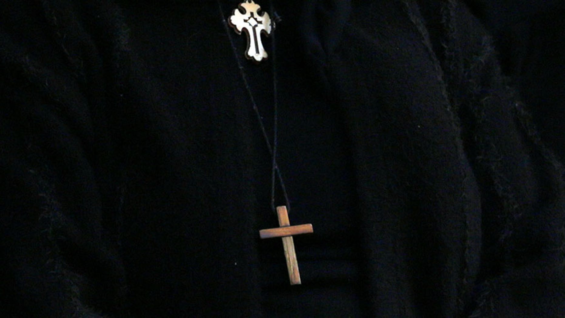 A cross is seen on the clothes of Egyptian Christians during the funeral of victims killed in the bombing of Cairo's Coptic cathedral, at the Mokattam Cemetery in Cairo, Egypt December 12, 2016. REUTERS/Amr Abdallah Dalsh - RTX2UP8B