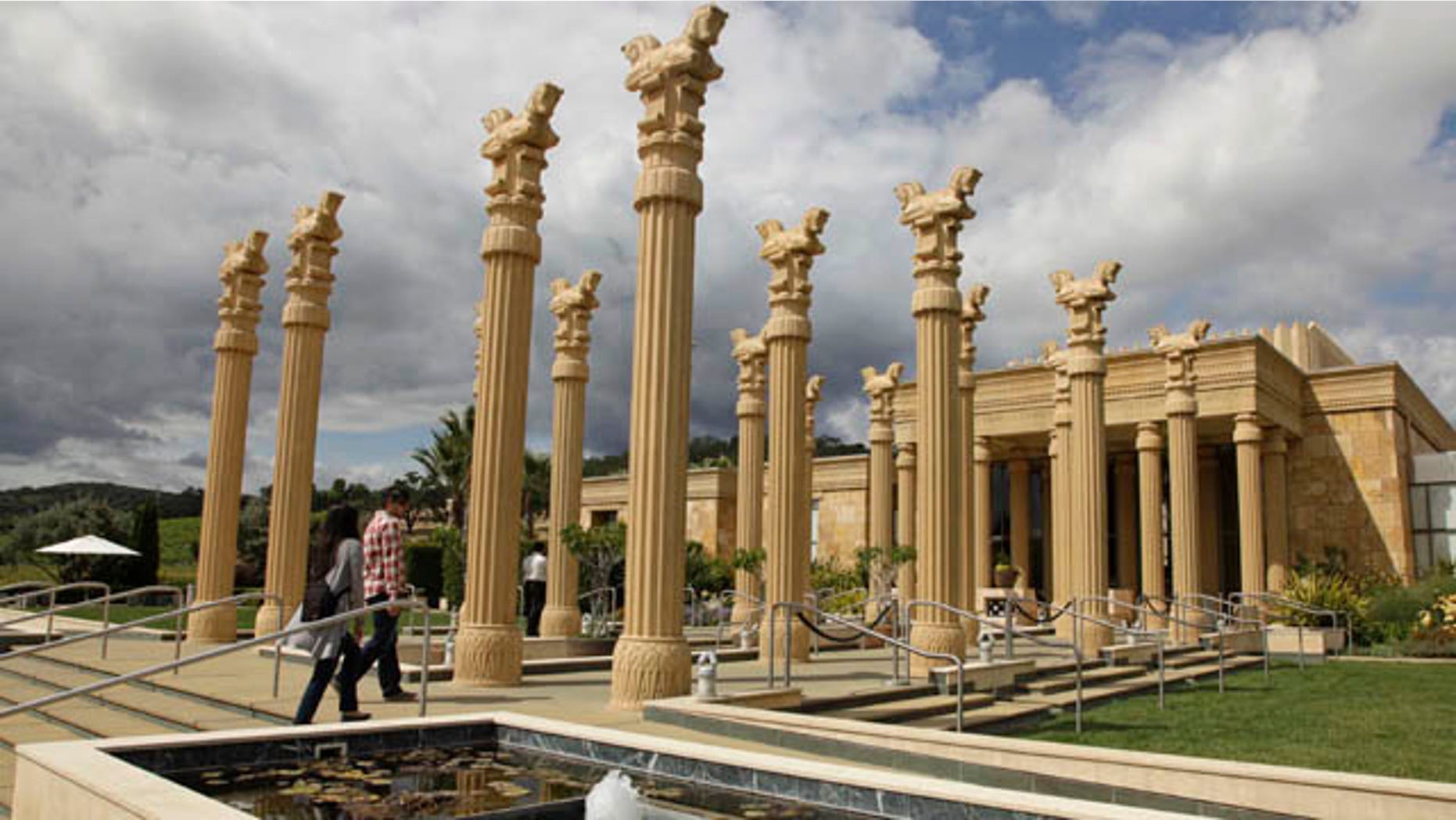 This Thursday, June 2, 2011 photo shows a couple as they make their way in the Darioush winery in Napa, Calif. The winery is notable for its striking architecture which incorporates references to Persepolis, the capital of ancient Persia. Blessed with lavish scenery and luscious wines, the Napa Valley is the kind of place you could spend days exploring. But its compact enough that even if you only have an afternoon you can still get a taste of wine country. (AP Photo/Eric Risberg)