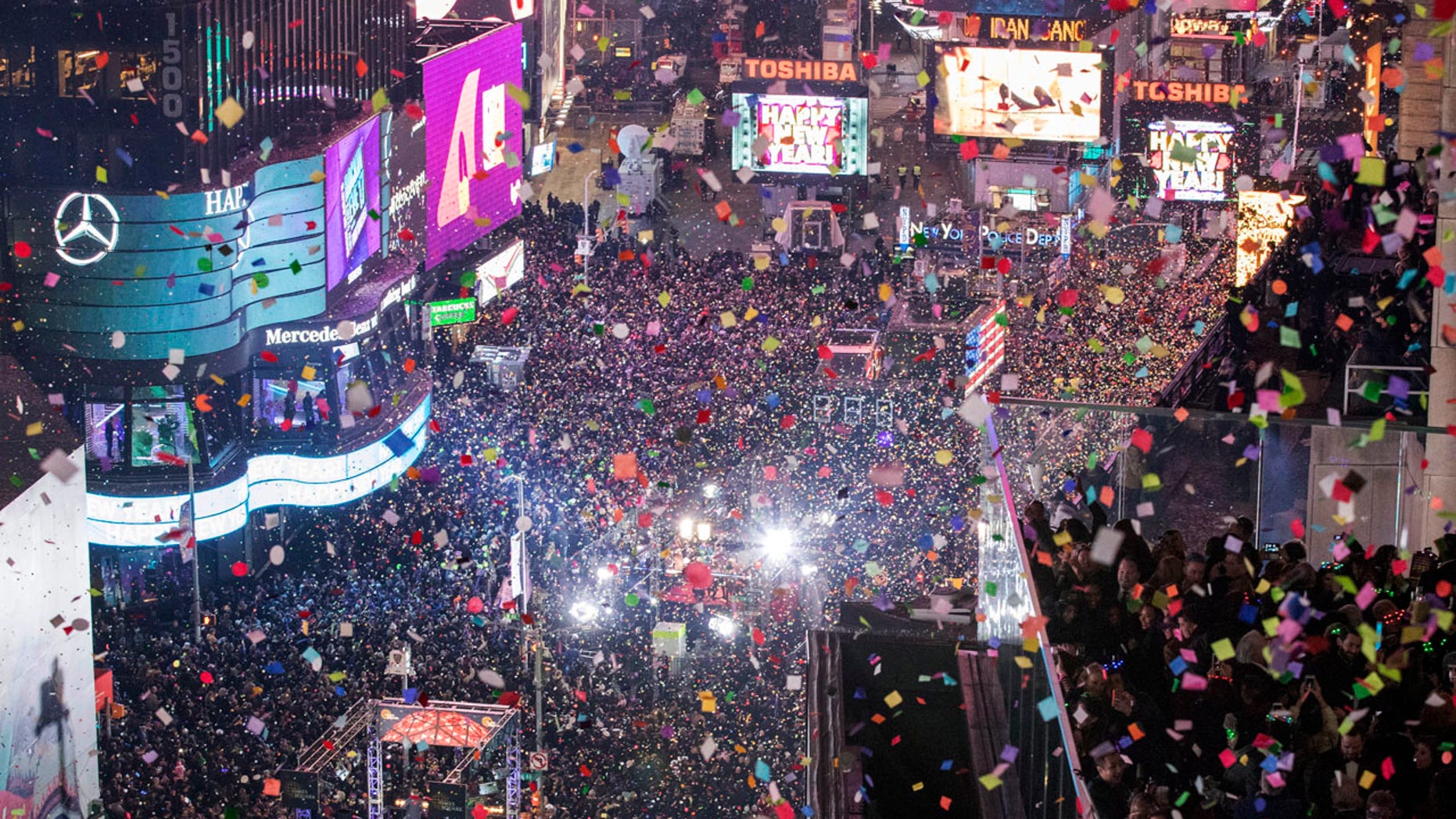 FILE -- Revelers celebrate the new year as confetti flies over New York's Times Square as seen from the Marriott Marquis, Sunday, Jan. 1, 2017.