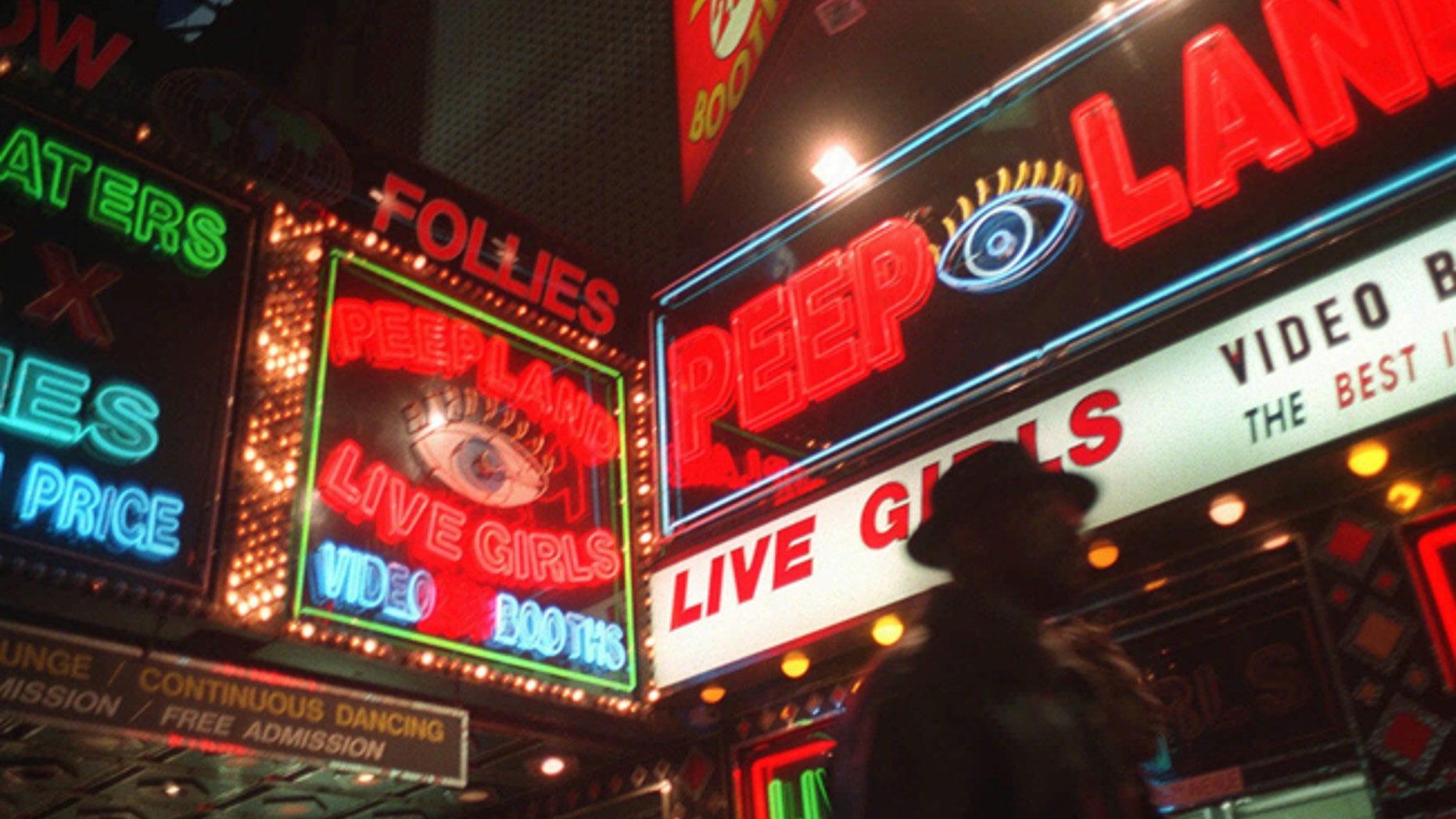A pedestrian walks past Peepland on Broadway in this March 6, 1998, file photo.
