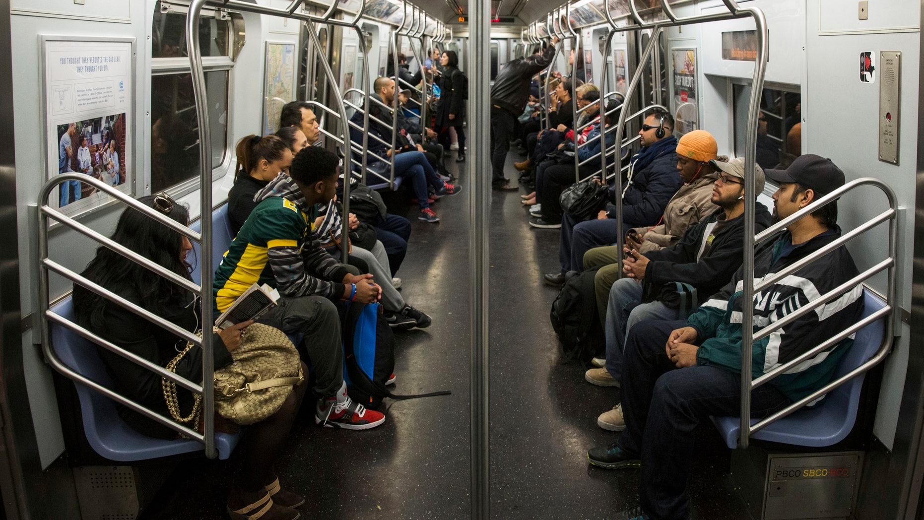 October 24, 2014 - Commuters ride a New York City L train. (REUTERS) Commuters