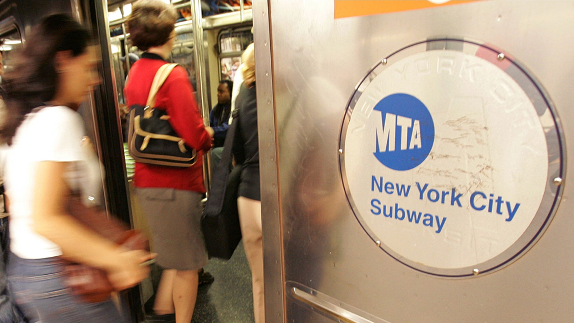 Riders board a subway train in New York City.