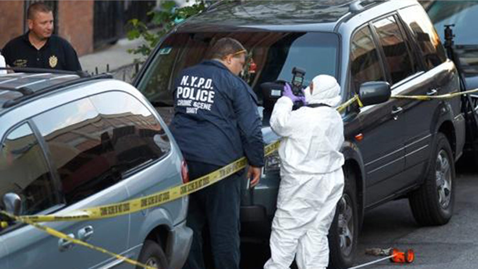 Police investigate the scene of the shooting.
