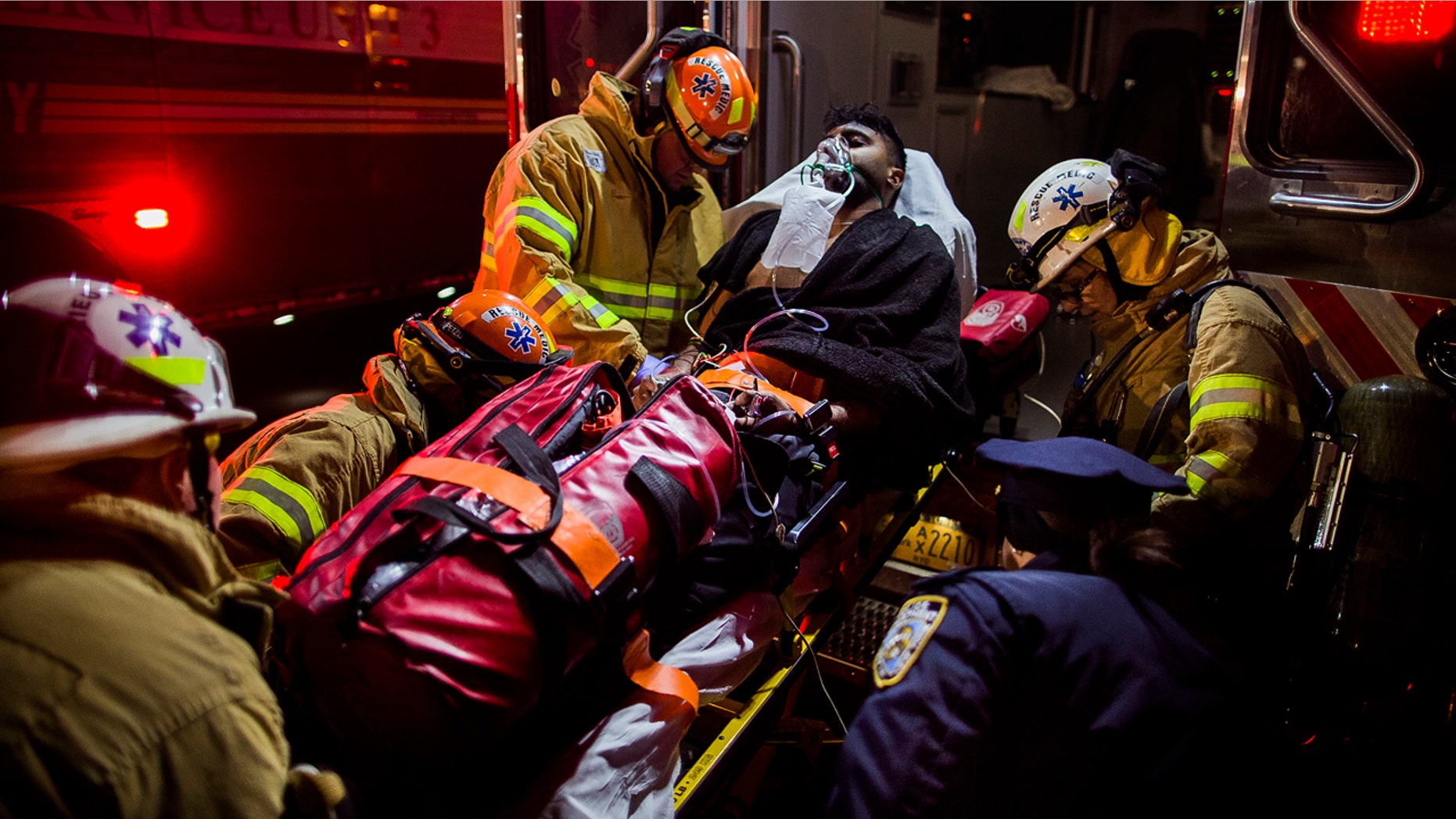 Dec. 22, 2016: Firefighters load an injured person into an ambulance during a fire on the west side of Manhattan in New York