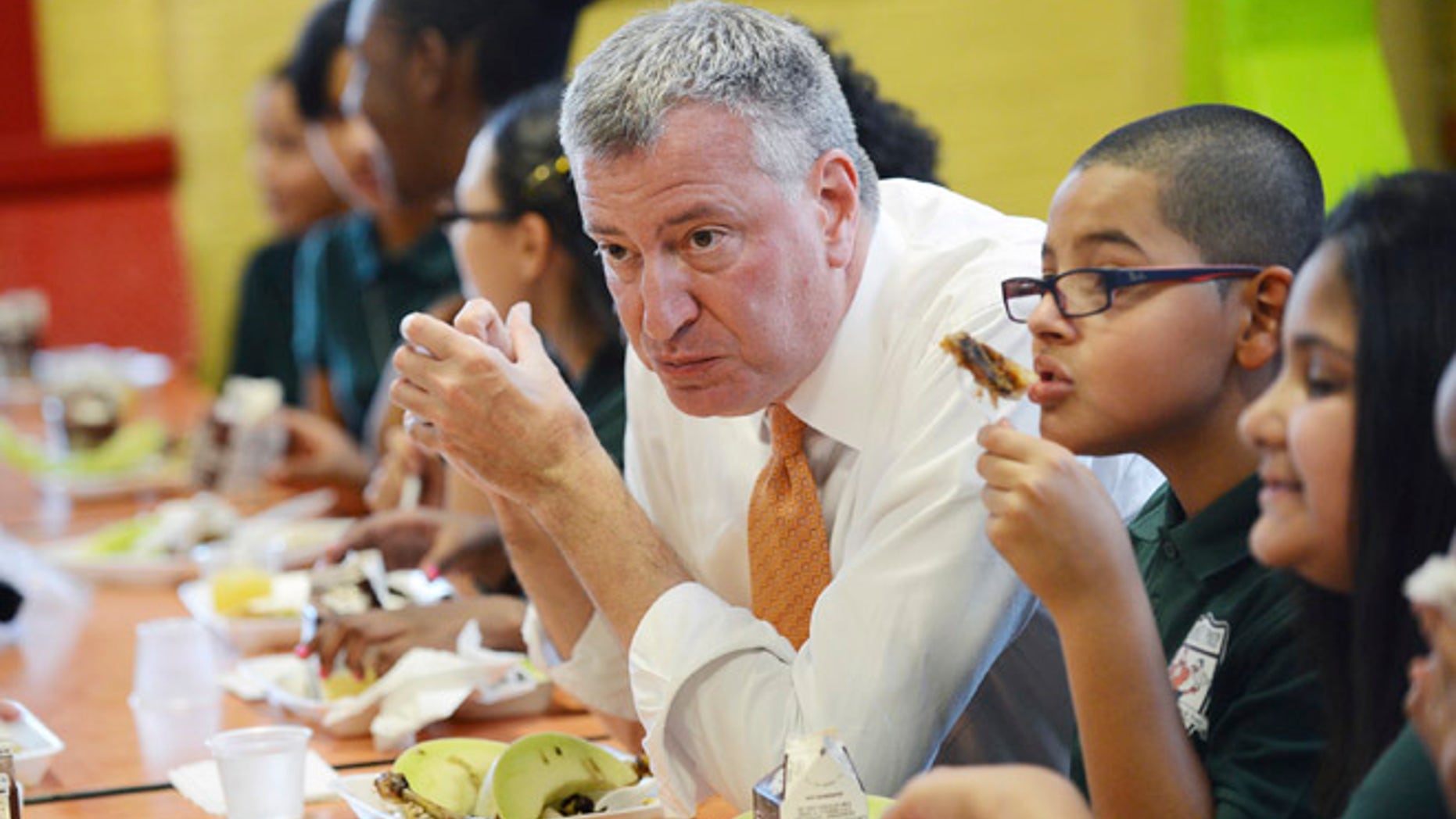 New York mayor Bill de Blasio eats lunch with fifth graders at Journey Prep School on the first day of the city's public school opening in the Bronx.
