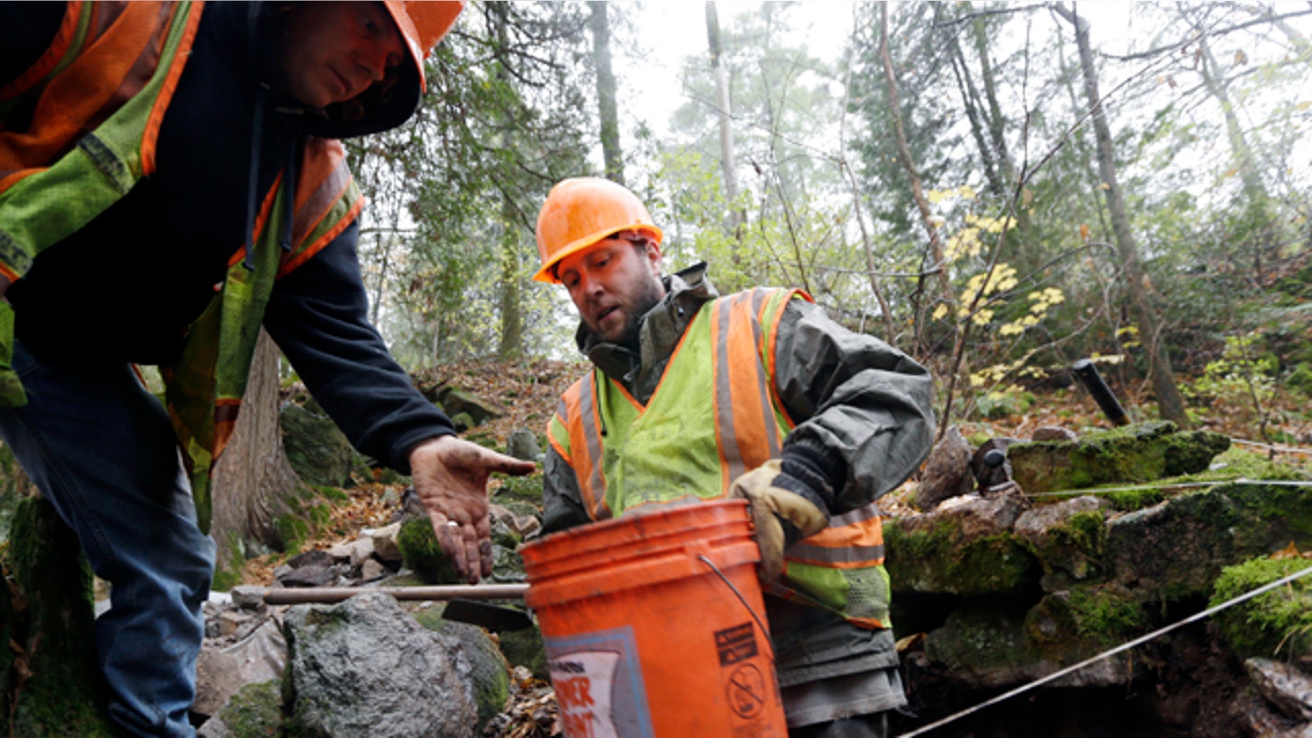 Oct. 31, 2013: State Museum archaeologists Daniel Mazeau, right, and Aaron Gore remove a bucket of rocks and dirt from a dig site.