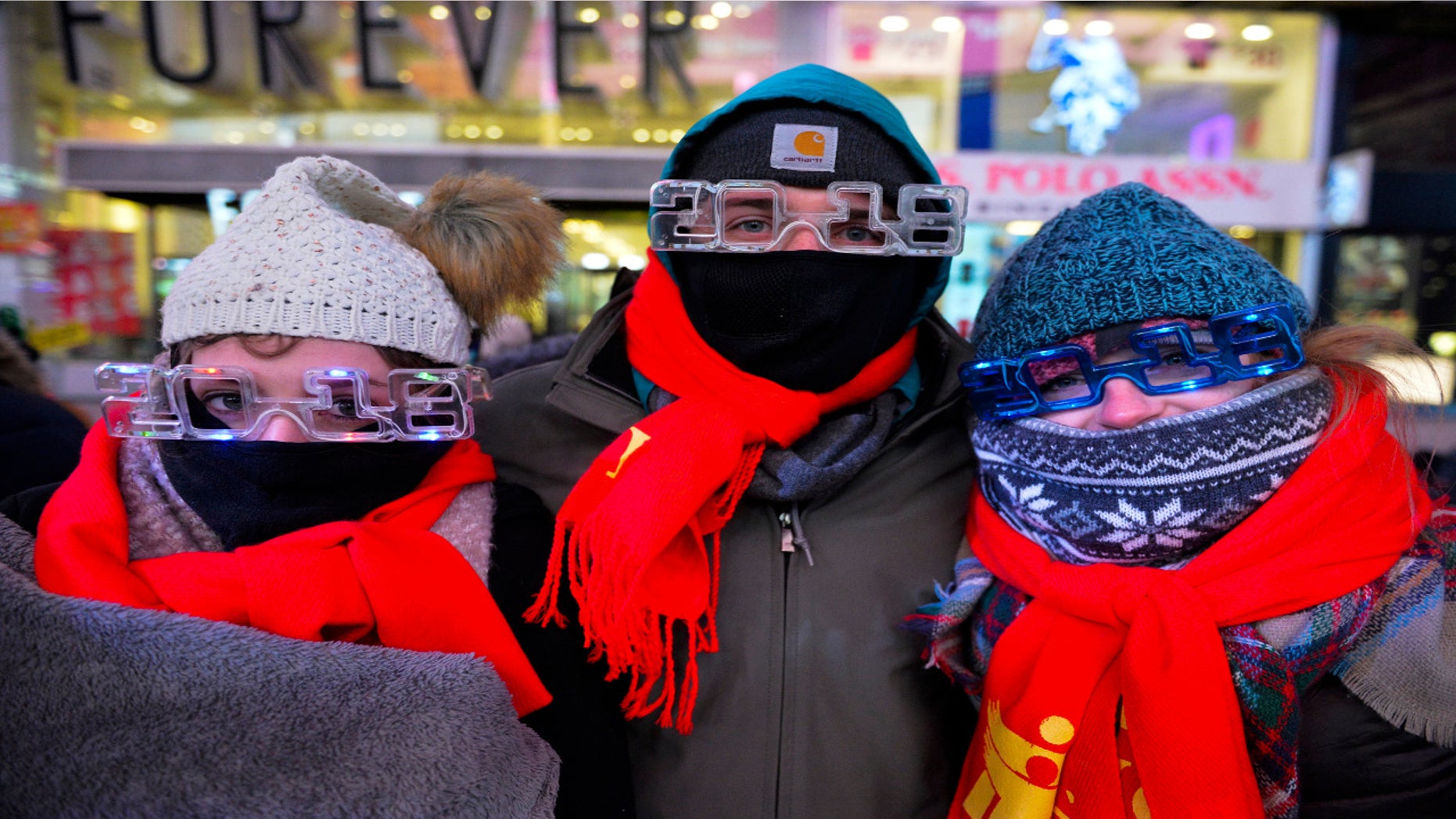 New Year's Eve revelers at Times Square in New York City dressed appropriately. From left are Elena Bardunniotis, Dominic Manshadi and Sarah Thompson, of Long Beach, Calif.