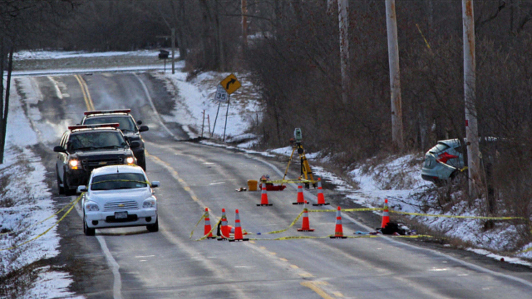 March 15, 2013: New York State Police investigate a car involved in a fatal carjacking on Verplank Road, Clay, N.Y.