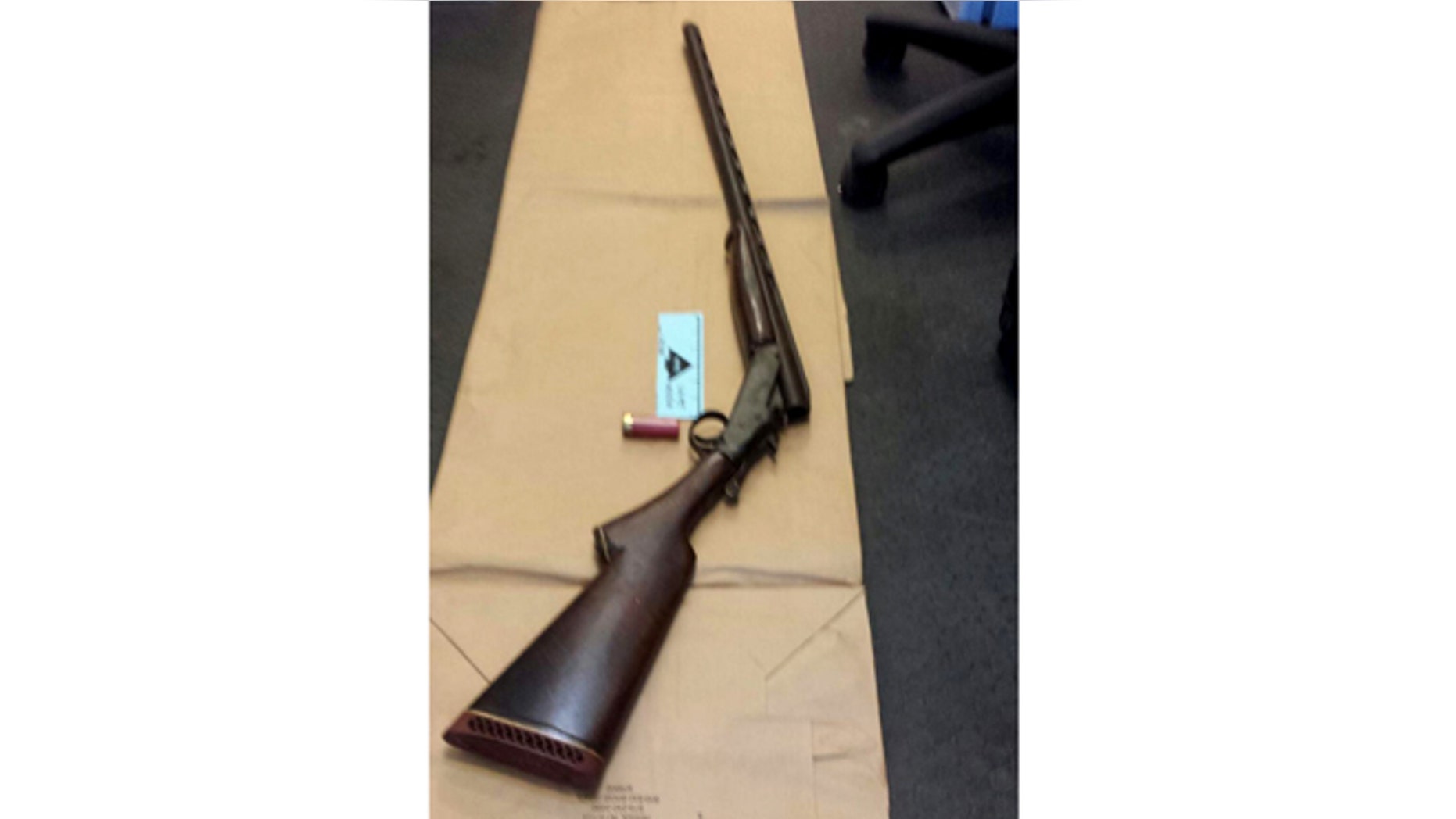 Apr. 12, 2014: This photo provided by the New York City Police Department shows a shotgun displayed on the floor of a police precinct in New York.