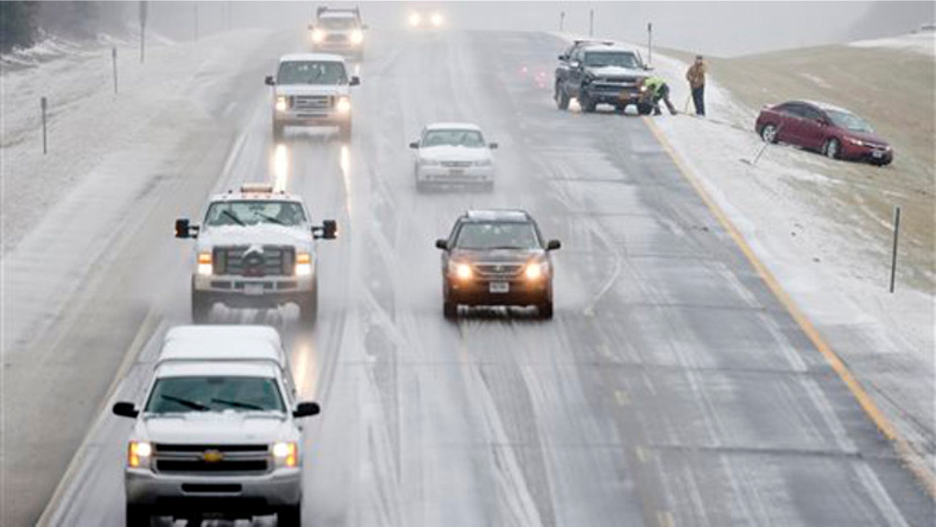 A vehicle is pulled from the median on Interstate 90 on Tuesday, Dec. 29, 2015, in East Greenbush, N.Y. Snow, sleet, freezing rain and gusty winds are creating treacherous driving conditions across upstate New York as eastern parts of the state receive their first severe weather of the winter season. (AP Photo/Mike Groll)