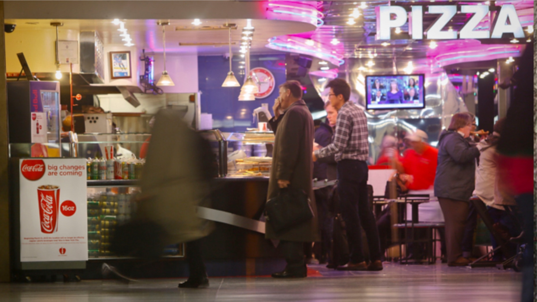 March 8, 2013: A Coca-Cola poster about the city's new beverage ban is displayed at a pizza shop at New York's Penn Station.