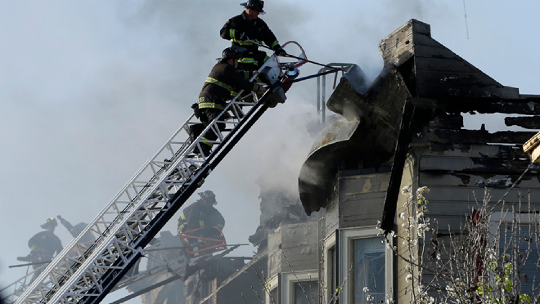 Firefighters battle an early morning apartment fire Monday, March 27, 2017, in Oakland, Calif. (AP Photo/Ben Margot)