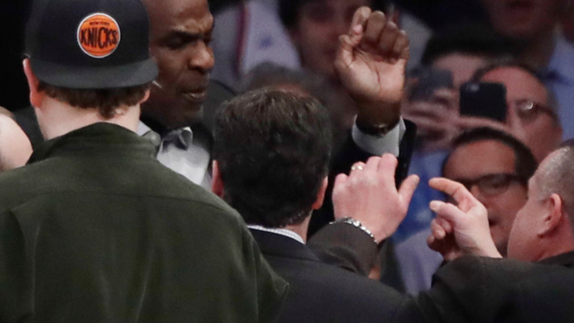 Charles Oakley is confronted by security personnel at Madison Square Garden during a Knicks game.