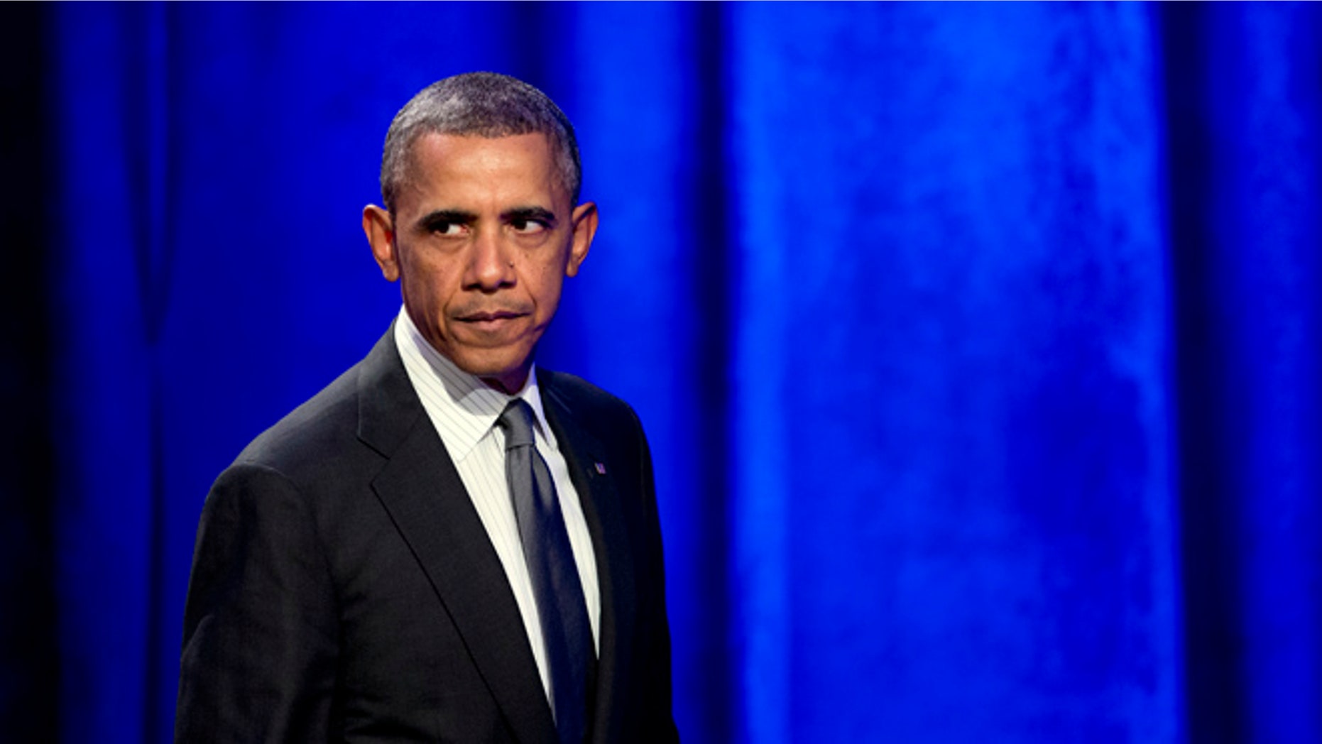 Feb. 25, 2014: President Obama glances at the crowd as walks off the stage after speaking at the National Organizing Summit in Washington.