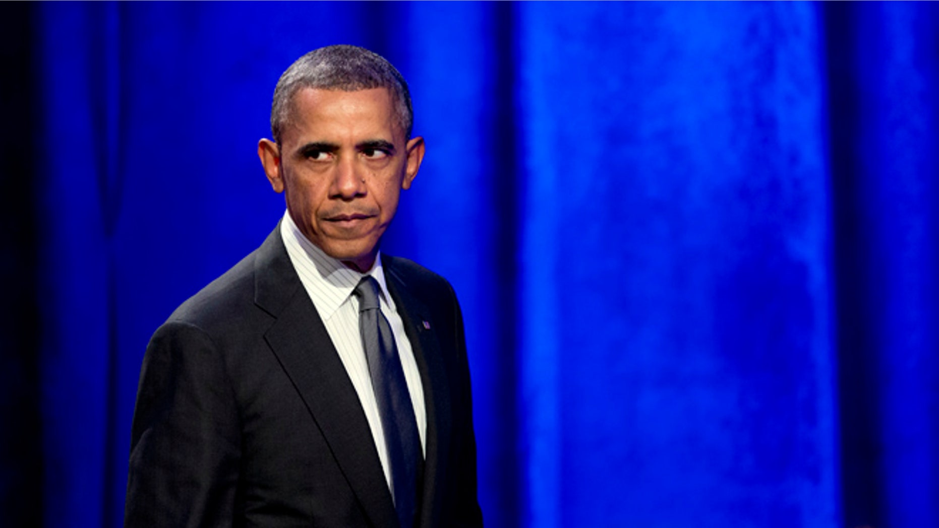 Feb. 25, 2014: President Obama glances at the crowd as walks off the stage after speaking at the National Organizing Summit in Washington.