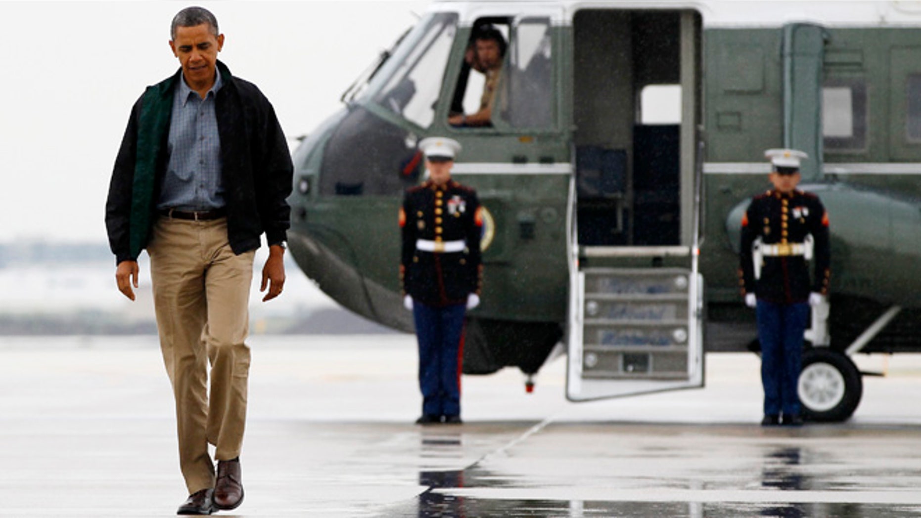 President Barack Obama walks from Marine One to board Air Force One at O'Hare International Airport in Chicago, Monday, Aug. 13, 2012 en route to Offutt Air Force Base in Bellevue, Neb., and onto a three day campaign bus tour through Iowa.