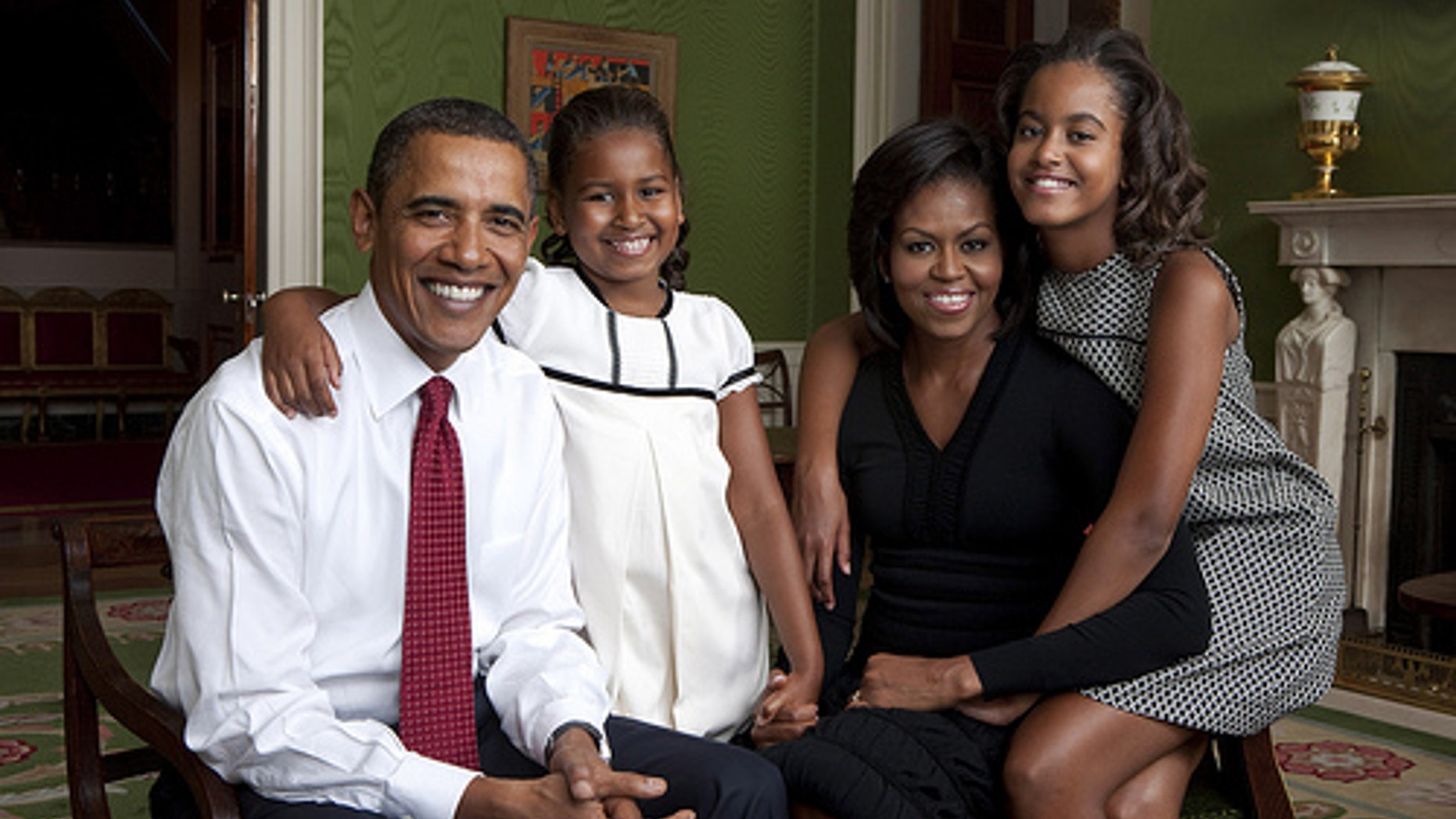 President Barack Obama, First Lady Michelle Obama, and their daughters, Malia and Sasha, sit for a family portrait in the Green Room of the White House, Sept. 1, 2009. (Official White House Photo)