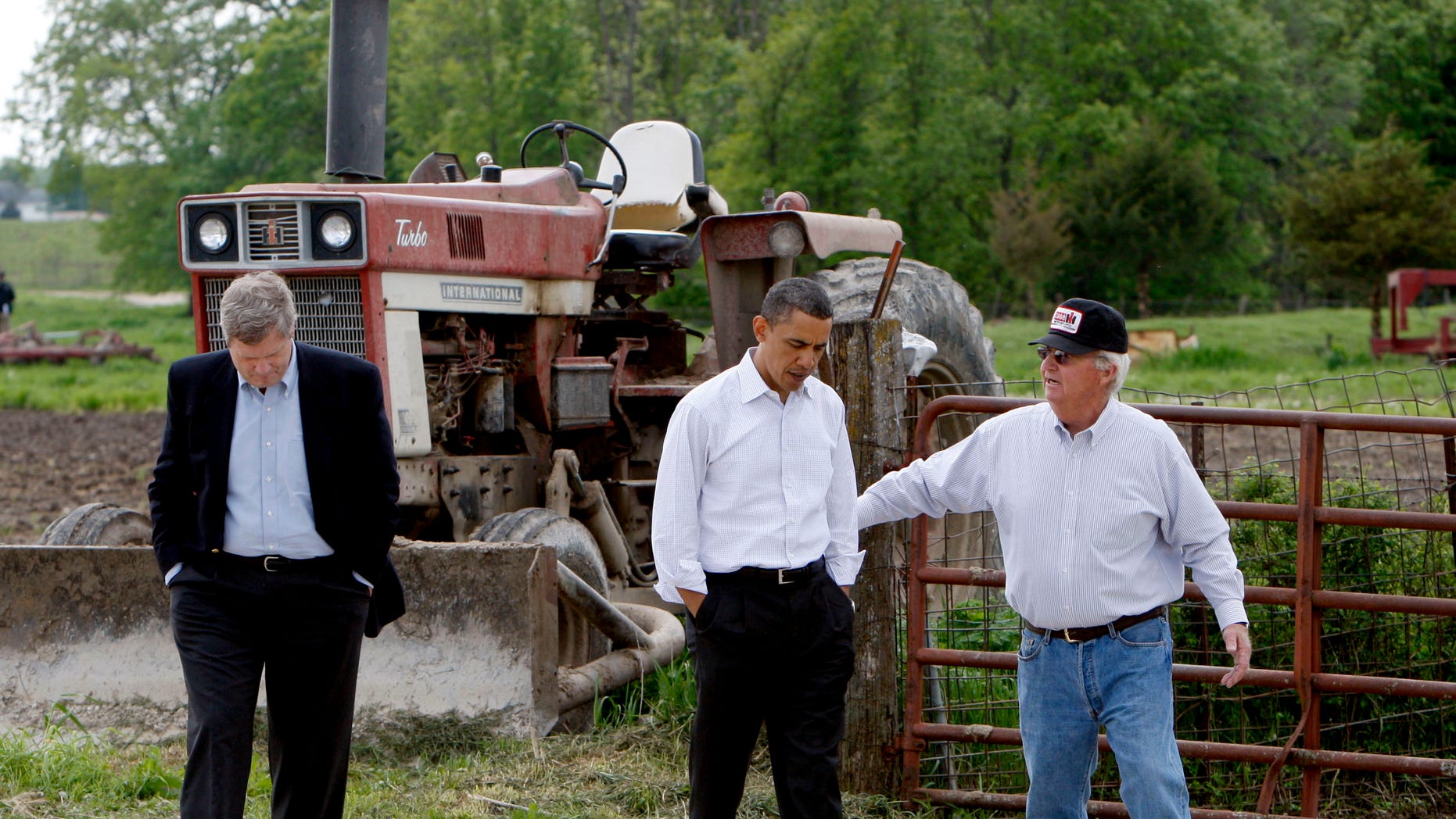 In this April 28, 2010, file photo President Barack Obama, and Agriculture Secretary Tom Vilsack, left, tour a farm in Palmyra, Mo., with owner Lowell Schachtsiek, right.