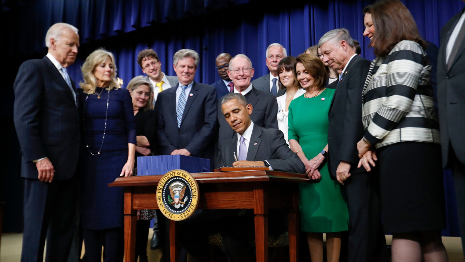 President Barack Obama signs the 21st Century Cures Act, Tuesday, Dec. 13, 2016, in the South Court Auditorium in the Eisenhower Executive Office Building on the White House complex in Washington.