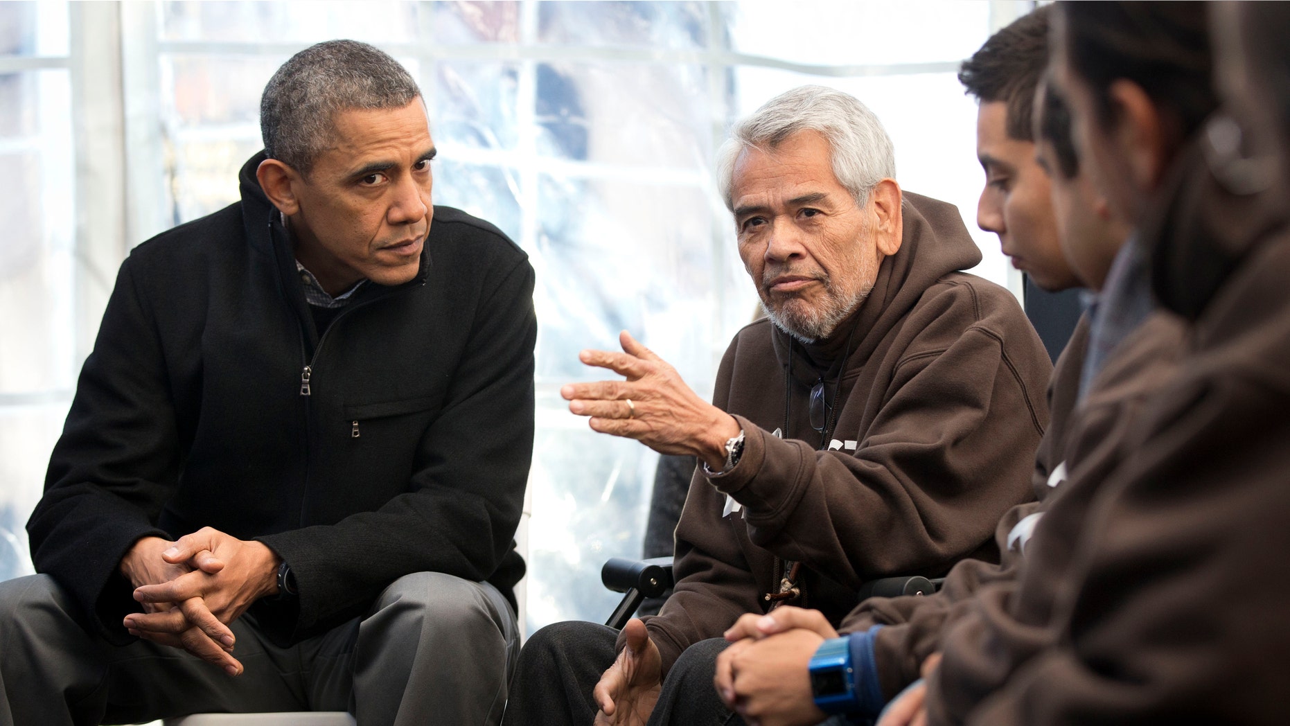 President Barack Obama, left, listens to Eliseo Medina, right, Secretary-Treasurer of Service Employees International Union (SEIU), as he meets with individuals who are taking part in Fast for Families on the National Mall in Washington, Friday, Nov. 29, 2013. Obama met with the group who are fasting on behalf of immigration reform. (AP Photo/Pablo Martinez Monsivais)