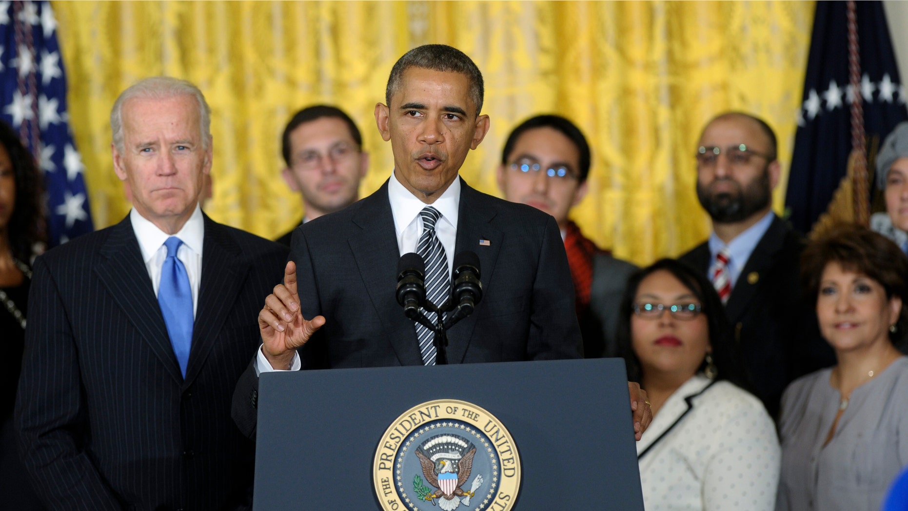 President Obama, standing next to Vice President Biden, urges Congress to take back up comprehensive immigration reform while speaking in the East Room of the White House in Washington, Thursday, Oct. 24, 2013.