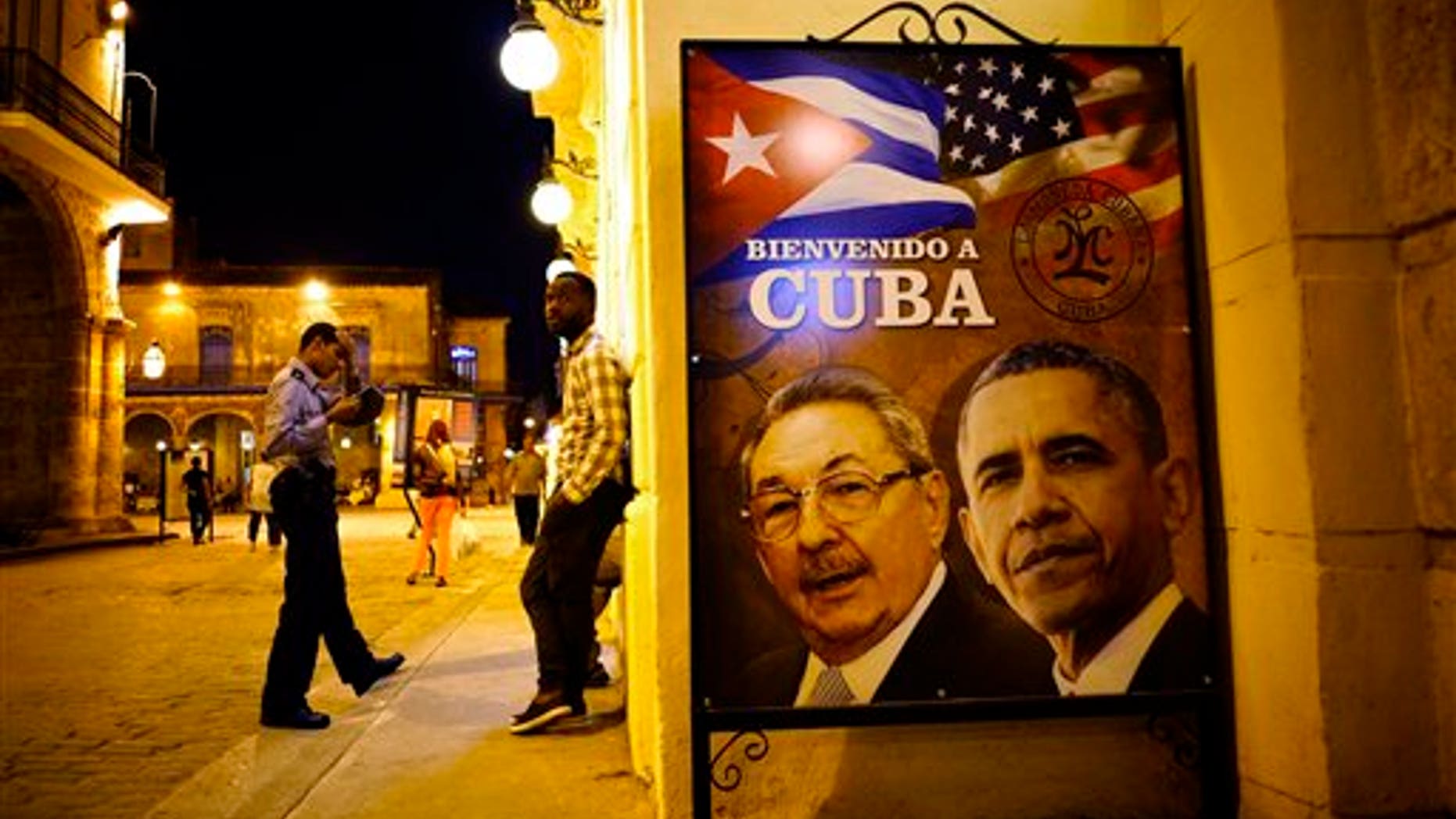A poster features portraits of Cuba's President Raul Castro, left, and U.S. President Barack Obama and reads in Spanish "Welcome to Cuba" outside a restaurant in Havana, Cuba, Thursday, March 17, 2016. Obama is scheduled to travel to the island on March 20, the first U.S. presidential trip to Havana in nearly 90 years. (AP Photo/Ramon Espinosa)
