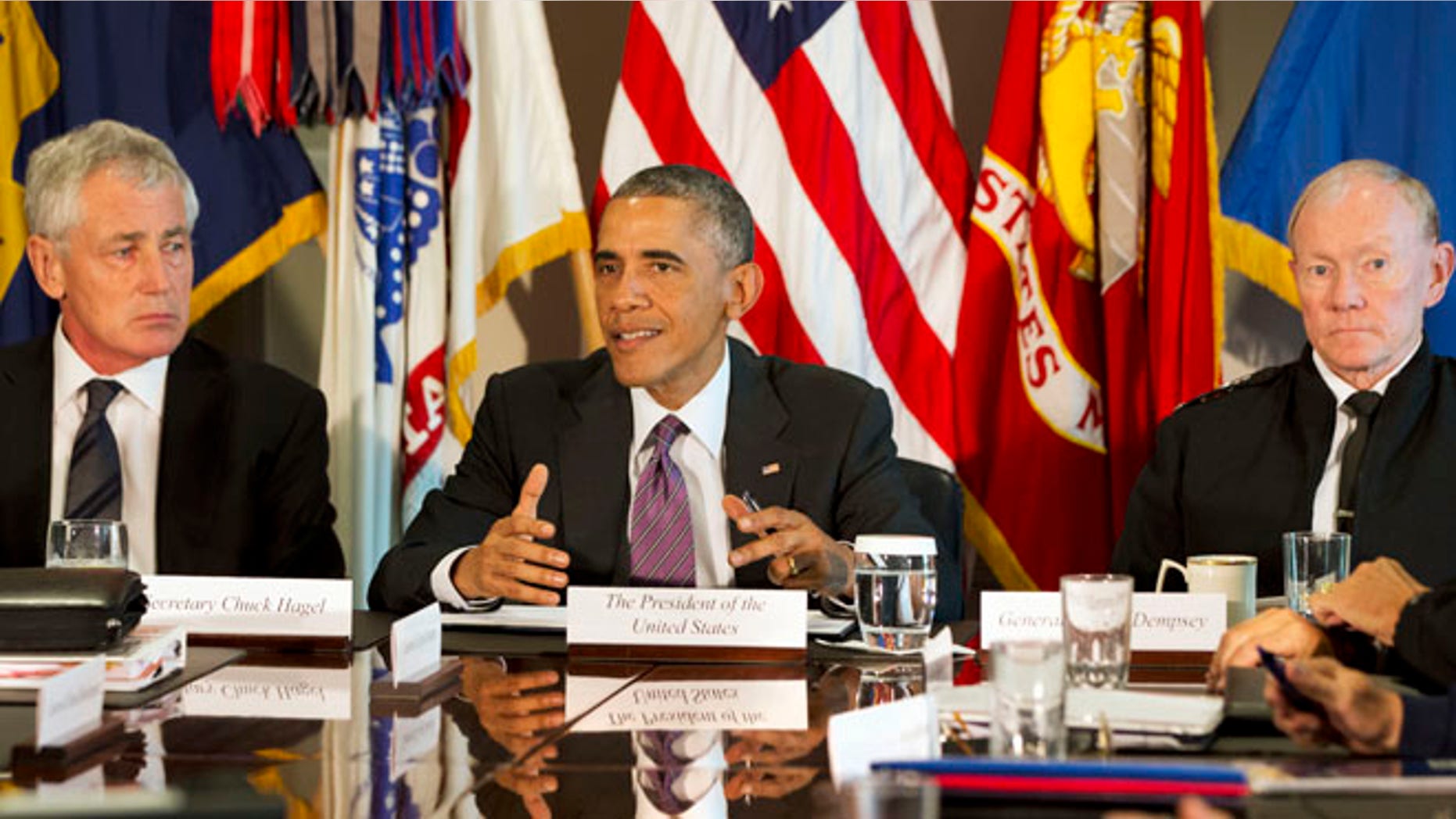 Oct. 8, 2014: President Barack Obama, flanked by Defense Secretary Chuck Hagel, left, and Joint Chiefs Chairman Gen. Martin Dempsey, speaks to the media at the conclusion of a meeting with senior military leadership