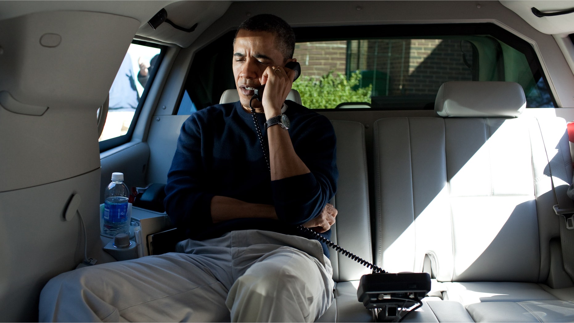 CHEVY CHASE, MD - MARCH 11: In this handout from the White House, U.S. President Barack Obama talks on the phone with Afghanistan President Hamid Karzai from his vehicle outside the Jane E. Lawton Community Center March 11, 2012 in Chevy Chase, Maryland. According to reports March 15, 2012, Afghan President Hamid Karzai wants Afghan forces to take over a year earlier in 2013 and wants U.S. troops to pull out of villages after a U.S. soldier allegedly killed 16 Afghan civilians. (Photo by Pete Souza/White House Photo via Getty Images)