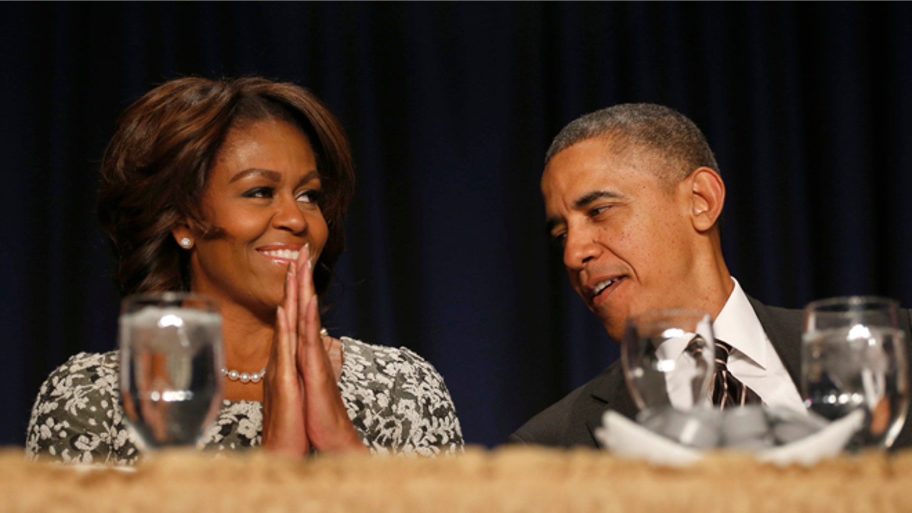 Feb. 6, 2014: President Obama and first lady Michelle Obama talk during the National Prayer Breakfast in Washington.