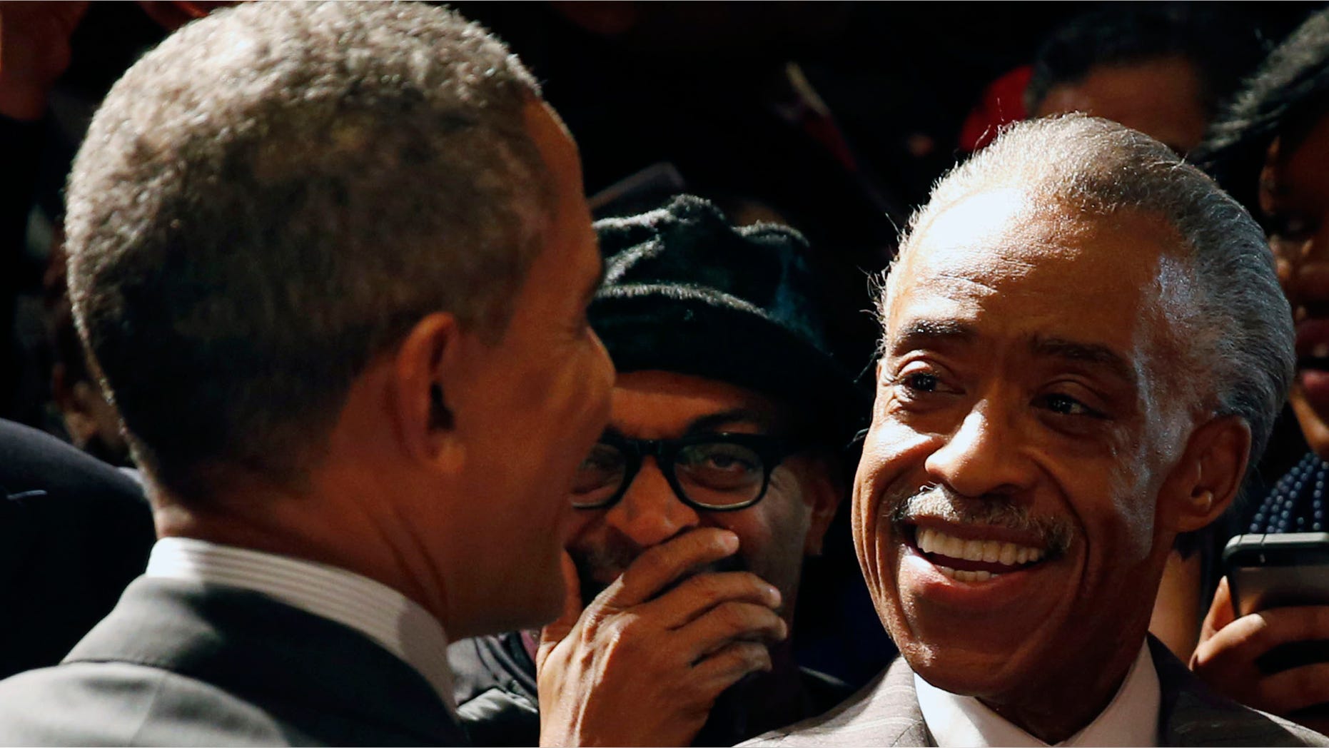 April 11, 2014: U.S. President Obama laughs with film director Spike Lee (C) and Reverend Al Sharpton (R).