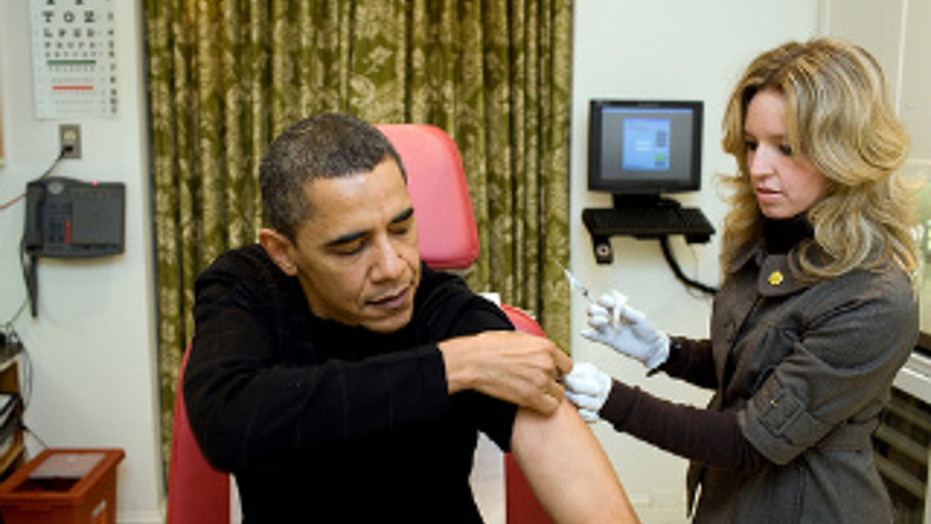 A White House nurse preps President Obama for the H1N1 flu shot. White House Photo.