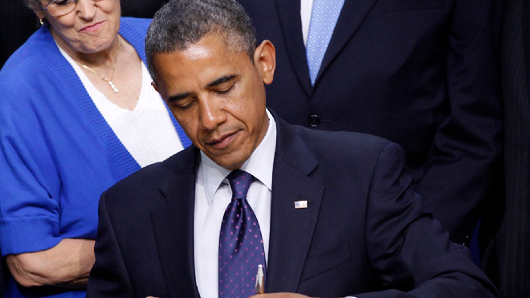 President Obama signs legislation in the Eisenhower Executive Office Building on the White House Campus in Washington.