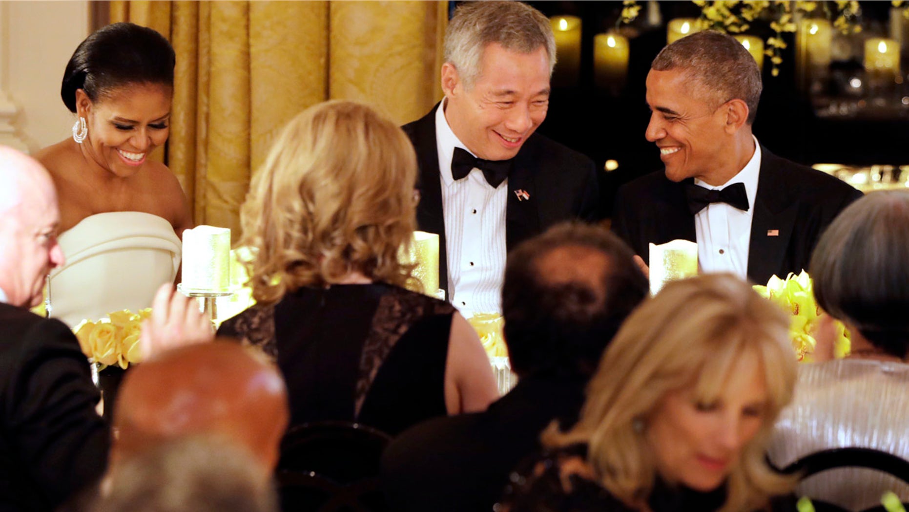 Aug. 2, 2016: President Barack Obama, right, and Singapore's Prime Minister Lee Hsien Loong, talk after toasting each other during a state dinner at the Whie House.