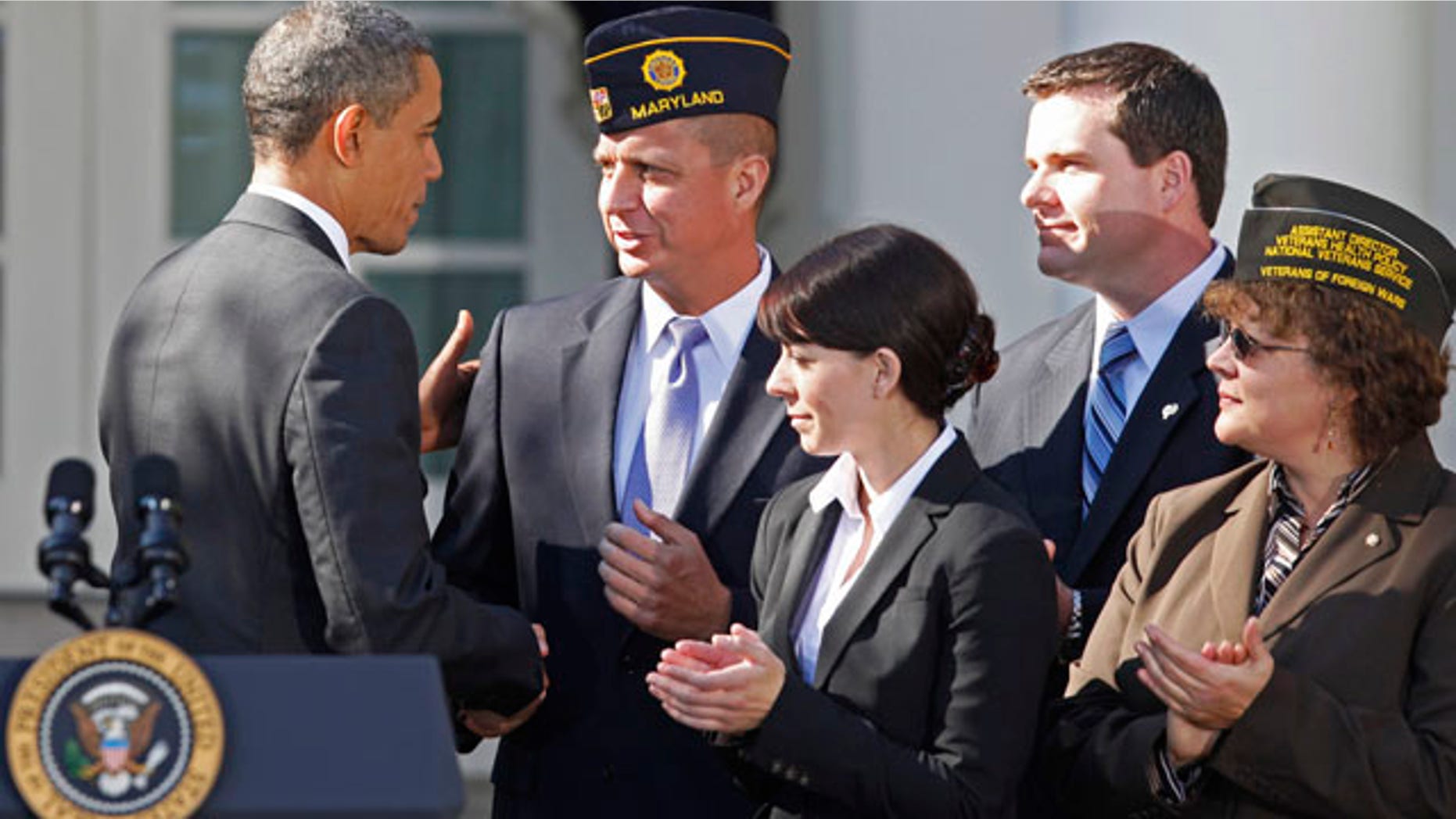 President Barack Obama greets veterans after he spoke about how tax credits would help them find jobs, Monday, Nov. 7, 2011, in the Rose Garden of the White House in Washington. (AP Photo/Charles Dharapak)
