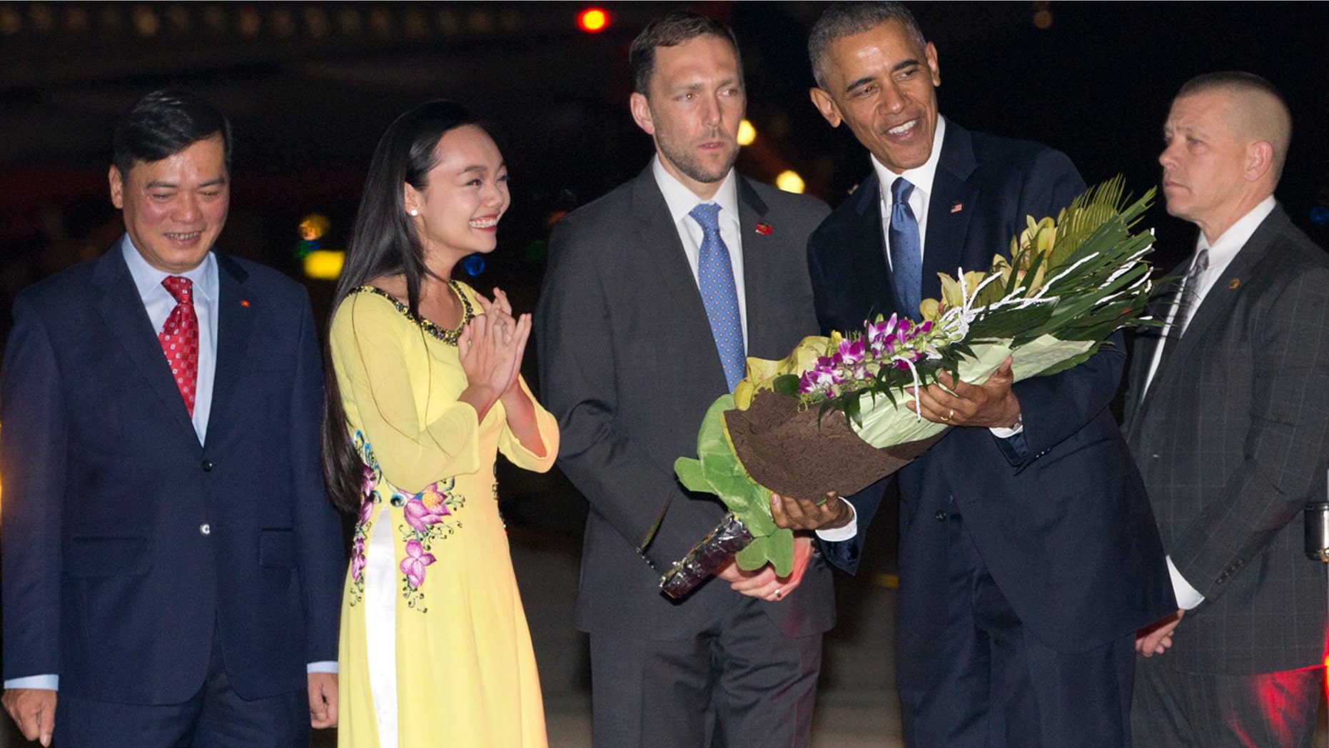 May 22, 2016: President Barack Obama is given flowers by Linh Tran, the ceremonial flower girl, as he arrives on Air Force One at Noi Bai International Airport in Hanoi, Vietnam.