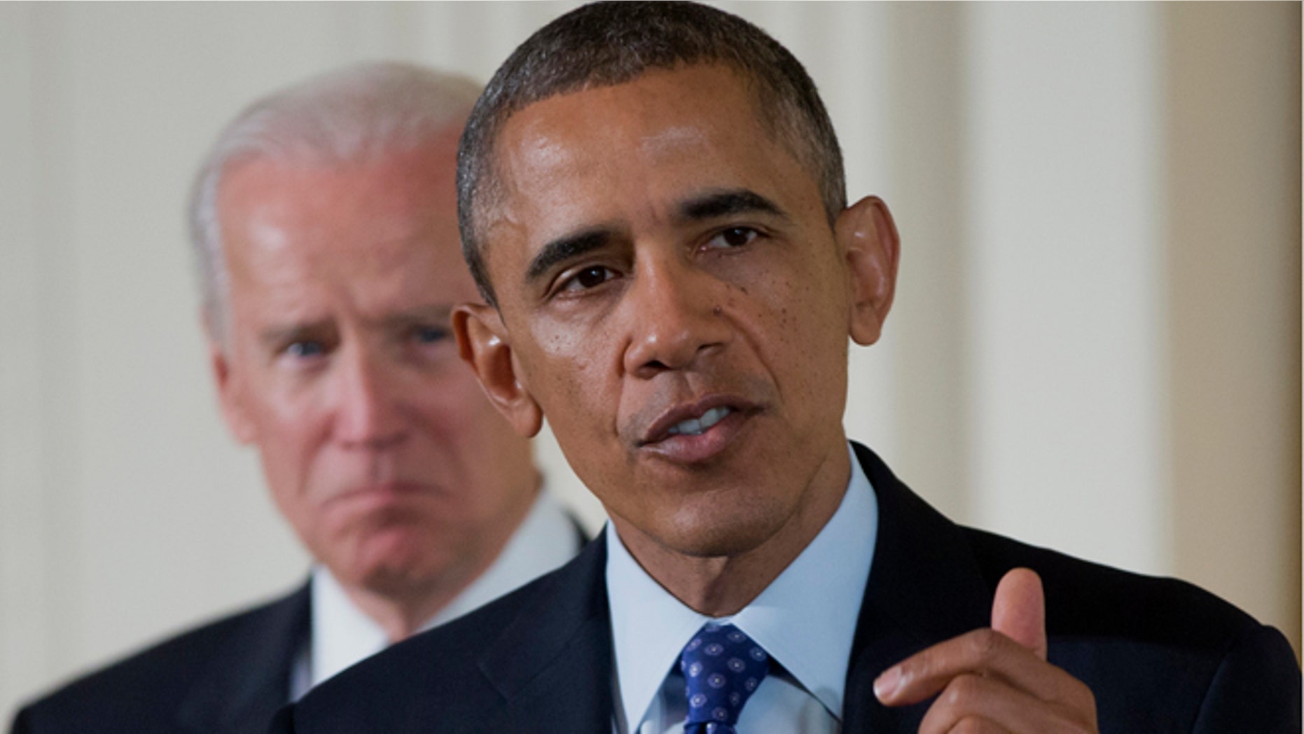 Jan. 22, 2014: Vice President Joe Biden listens as President Barack Obama speaks in the East Room of the White House in Washington.
