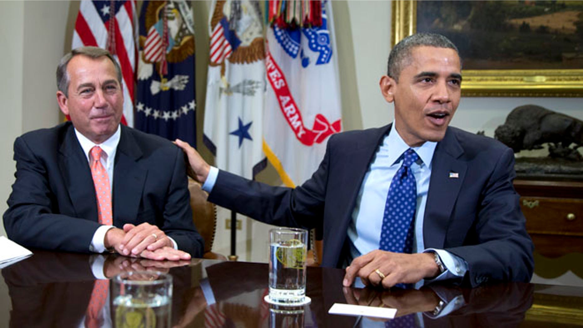 FILE 2012: President Obama acknowledges House Speaker John Boehner of Ohio while speaking to reporters in the Roosevelt Room of the White House in Washington.