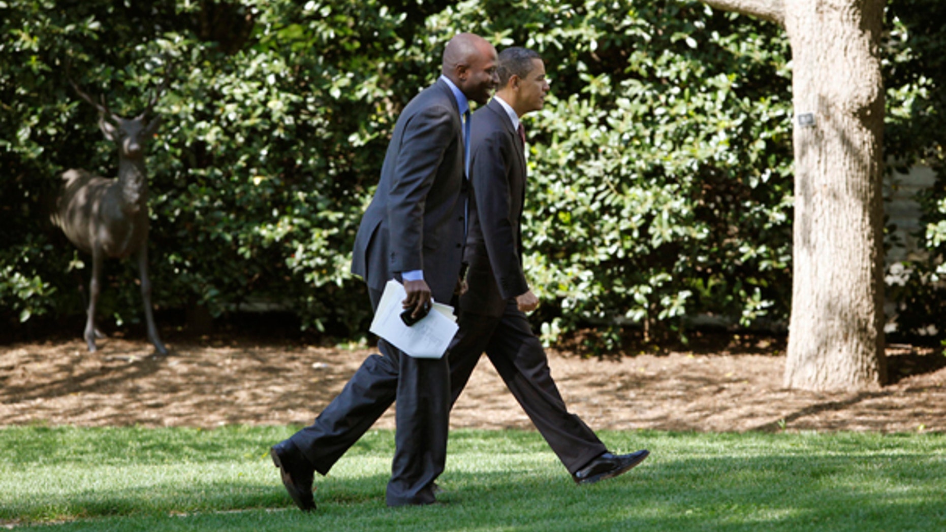 President Obama walks with aide Reggie Love, to the Oval Office of the White House in Washington, Friday, April 16, 2010. (AP)