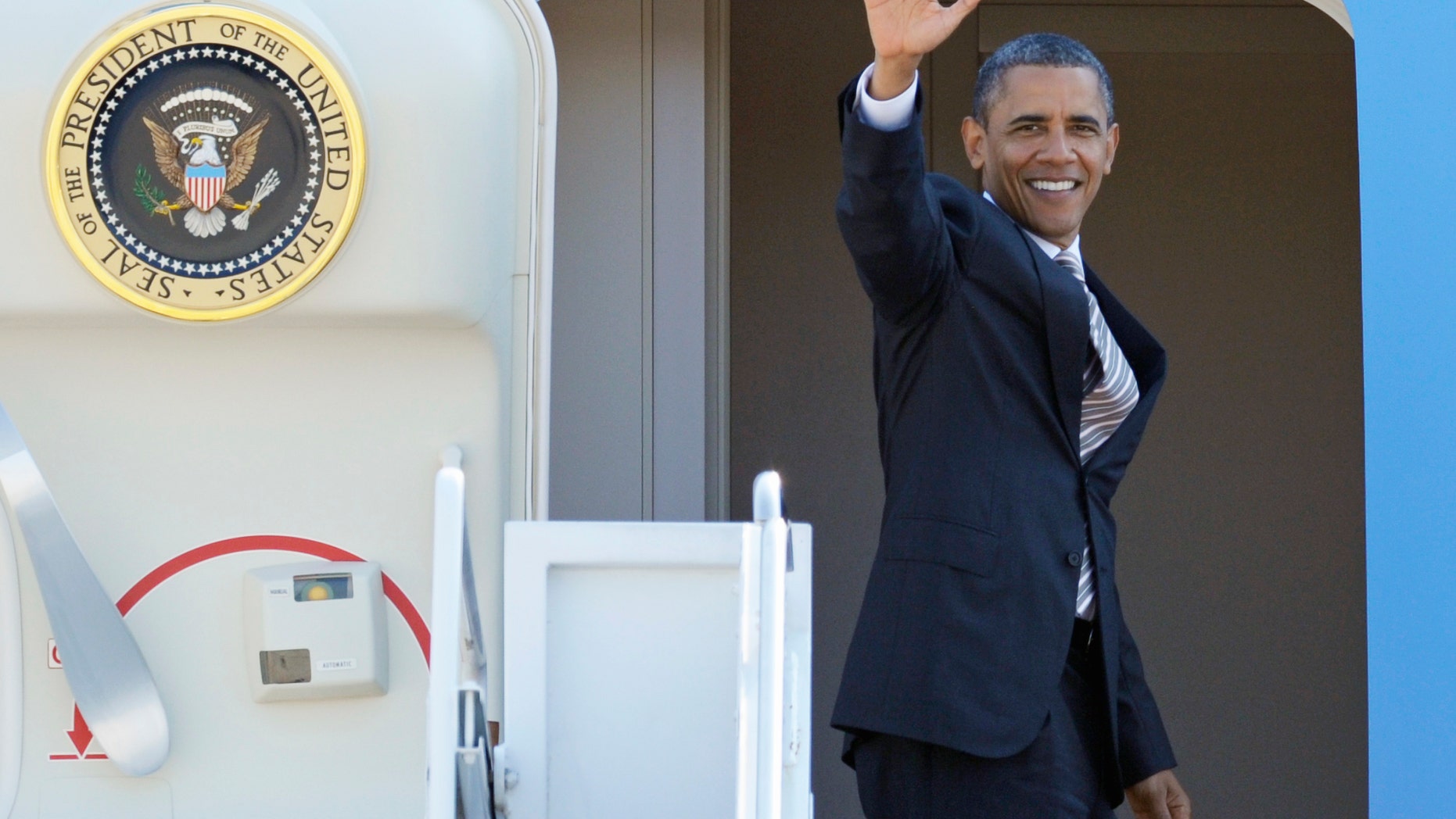 President Obama waves as he boards Air Force One at Andrews Air Force Base, Md., Wednesday, Sept. 14, 2011.