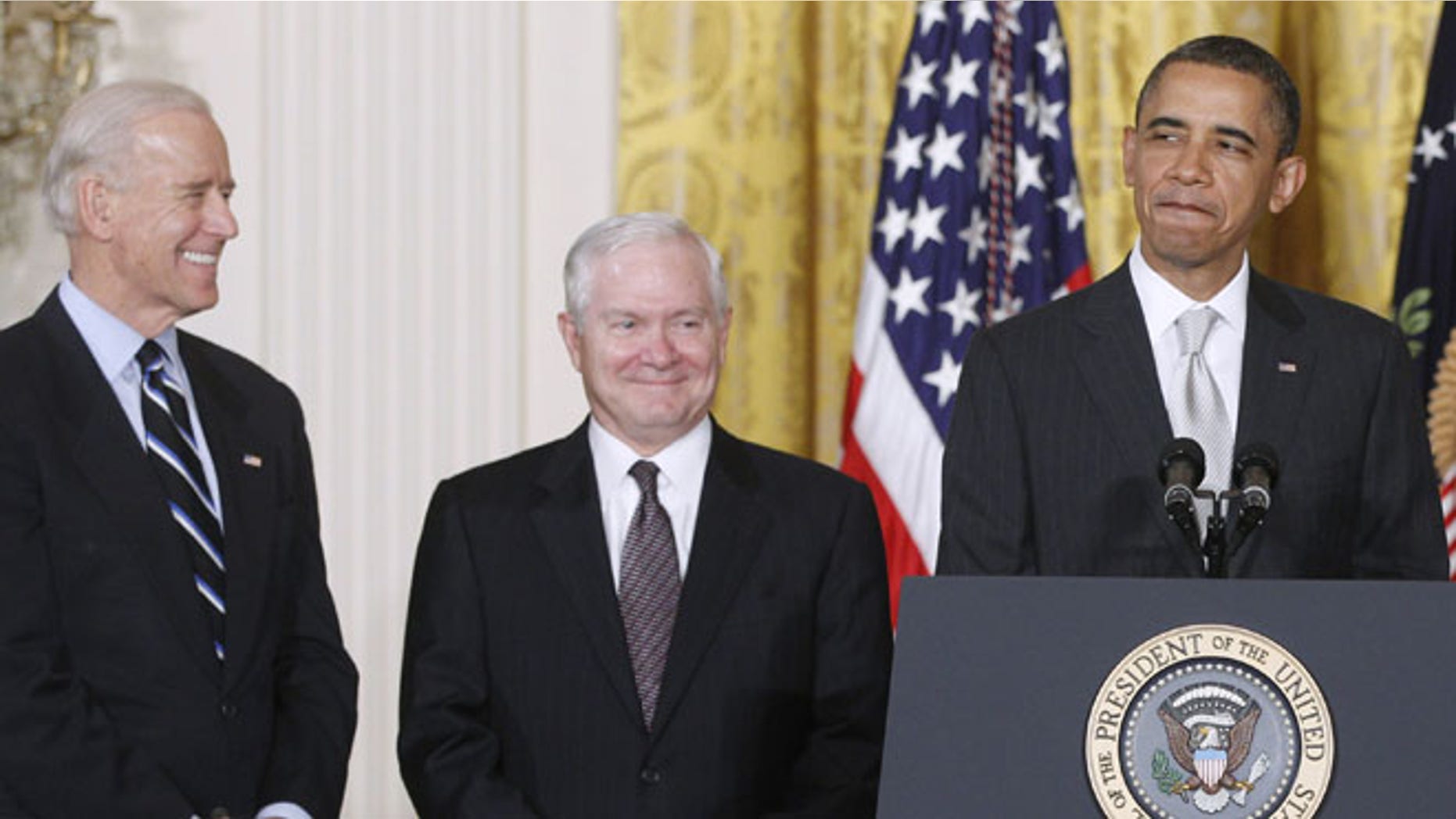In this April 28. 2011 file photo, President Obama stands in the East Room of the White House in Washington with Vice President Biden and then-outgoing Defense Secretary Robert Gates.