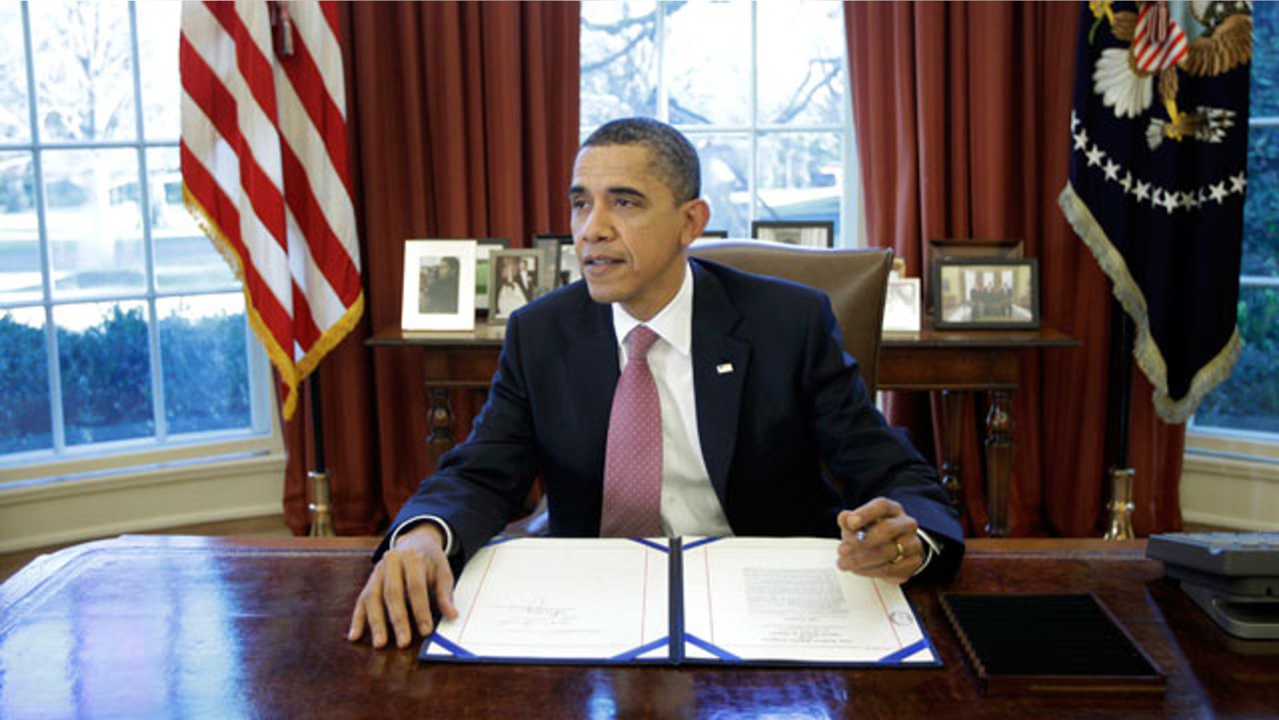 President Obama signs the two-week funding bill averting a government shutdown in the Oval Office at the White House in Washington, Wednesday, March 2, 2011. (AP)