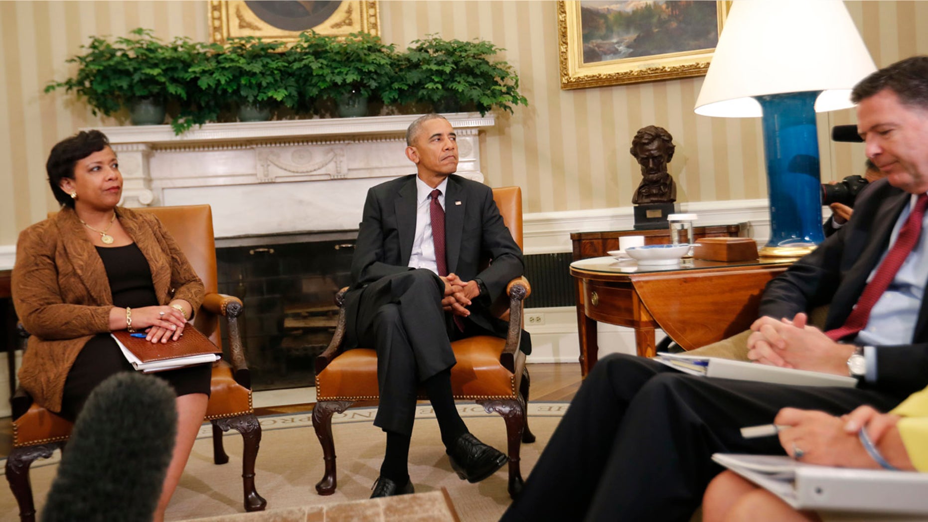 July 19, 2016: President Barack Obama, center, with Attorney General Loretta Lynch, left, and FBI Director James Comey, right, sit during their meeting in the Oval Office of the White House in Washington