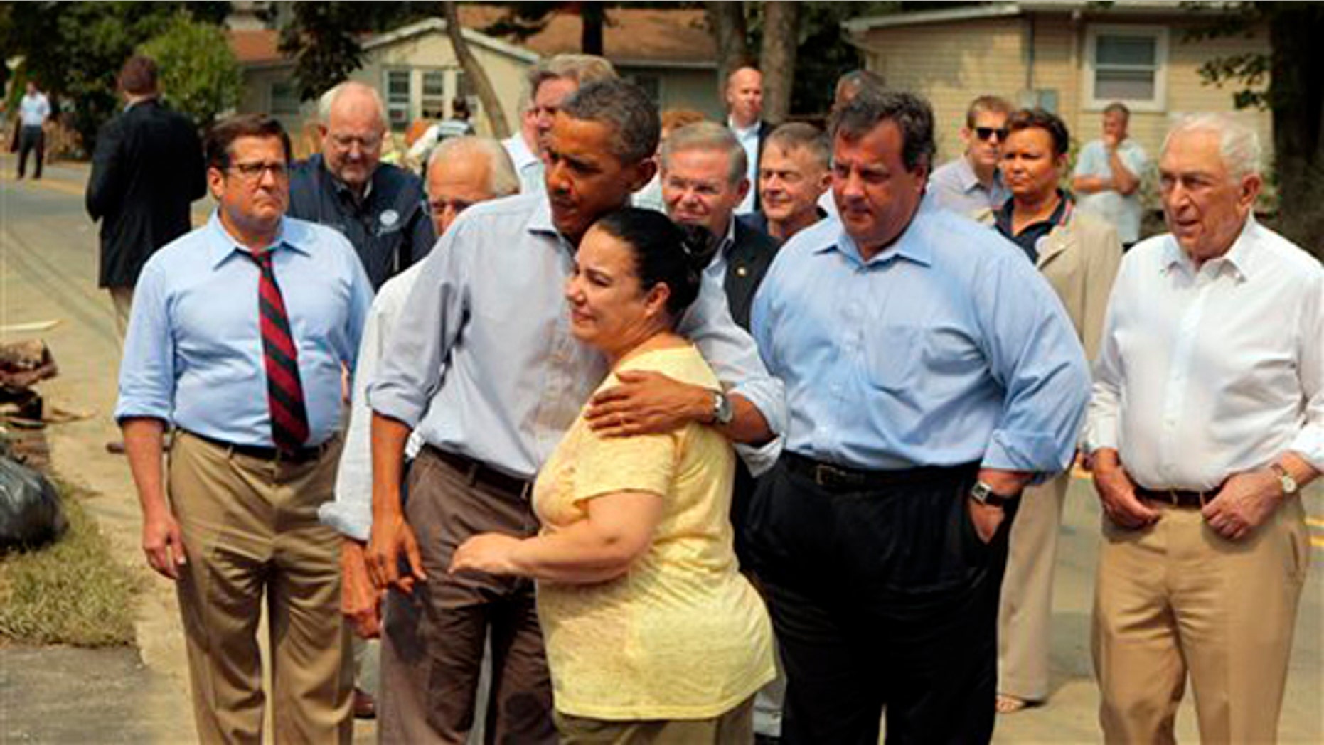 President Obama hugs a woman on a flood damaged street in Wayne, N.J., as he visits areas damaged by Hurricane Irene Sept. 4. At right is New Jersey Gov. Chris Christie.